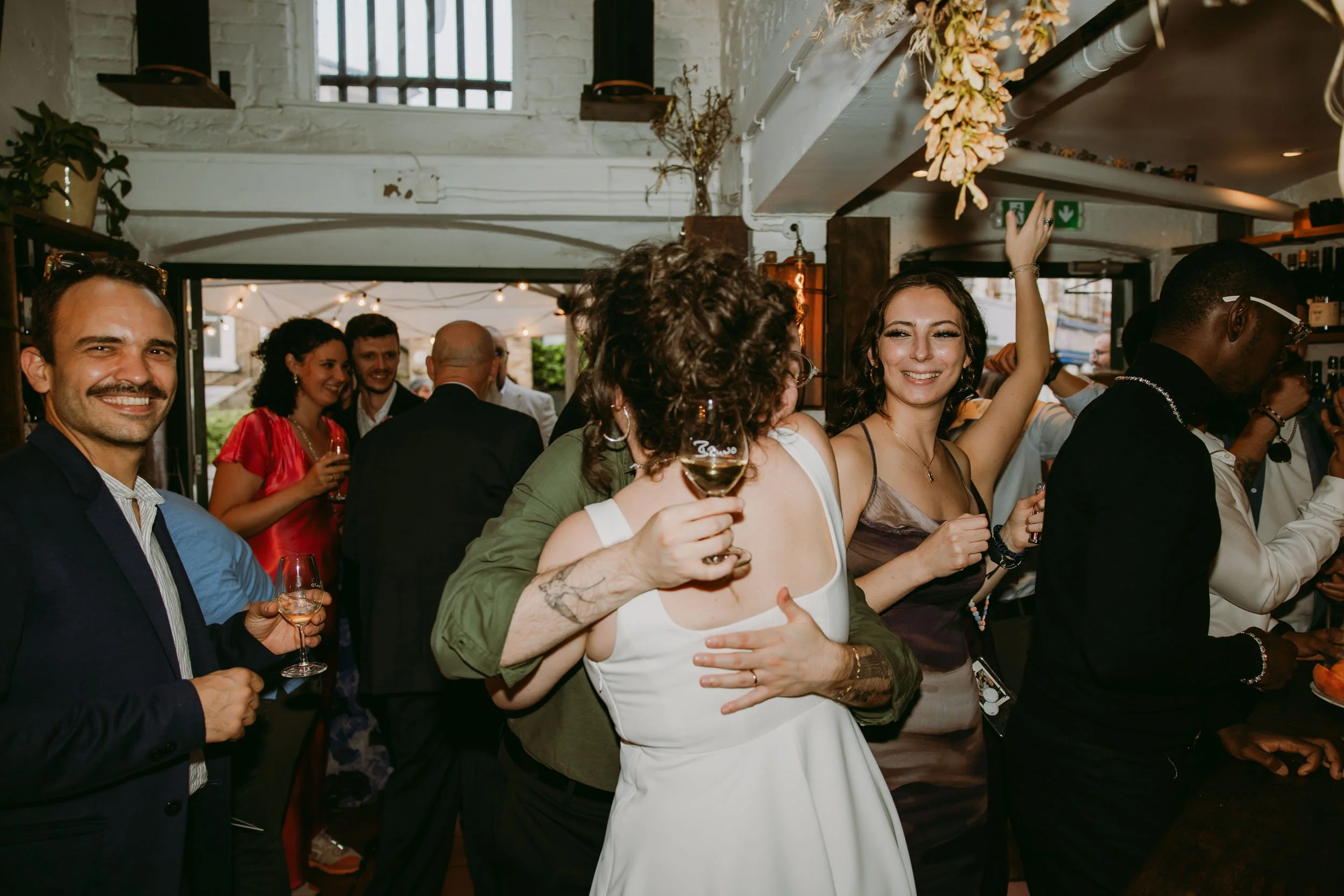wedding guests enjoying wedding party at bruno wine bar victoria park london