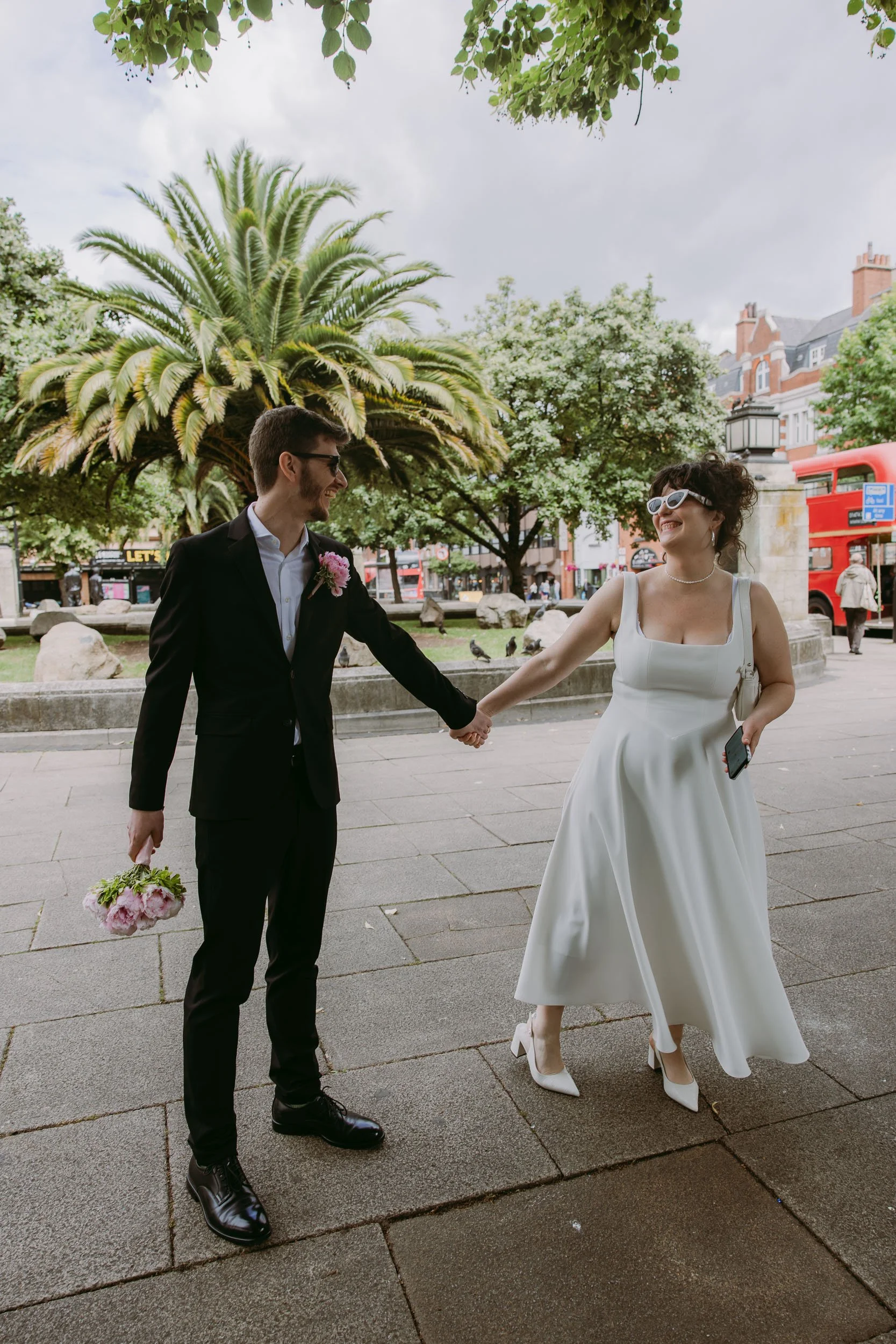 bride and groom smiling outside hackney town hall london wedding photographer