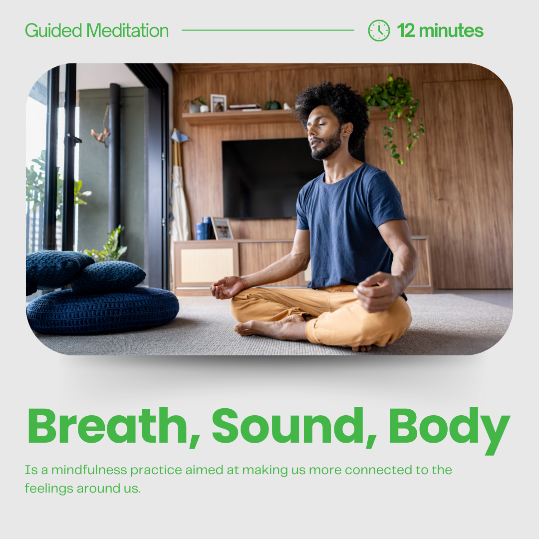 A man practicing meditation in a living room, sitting cross-legged on the floor with eyes closed, in a peaceful environment with natural light and minimal decor.