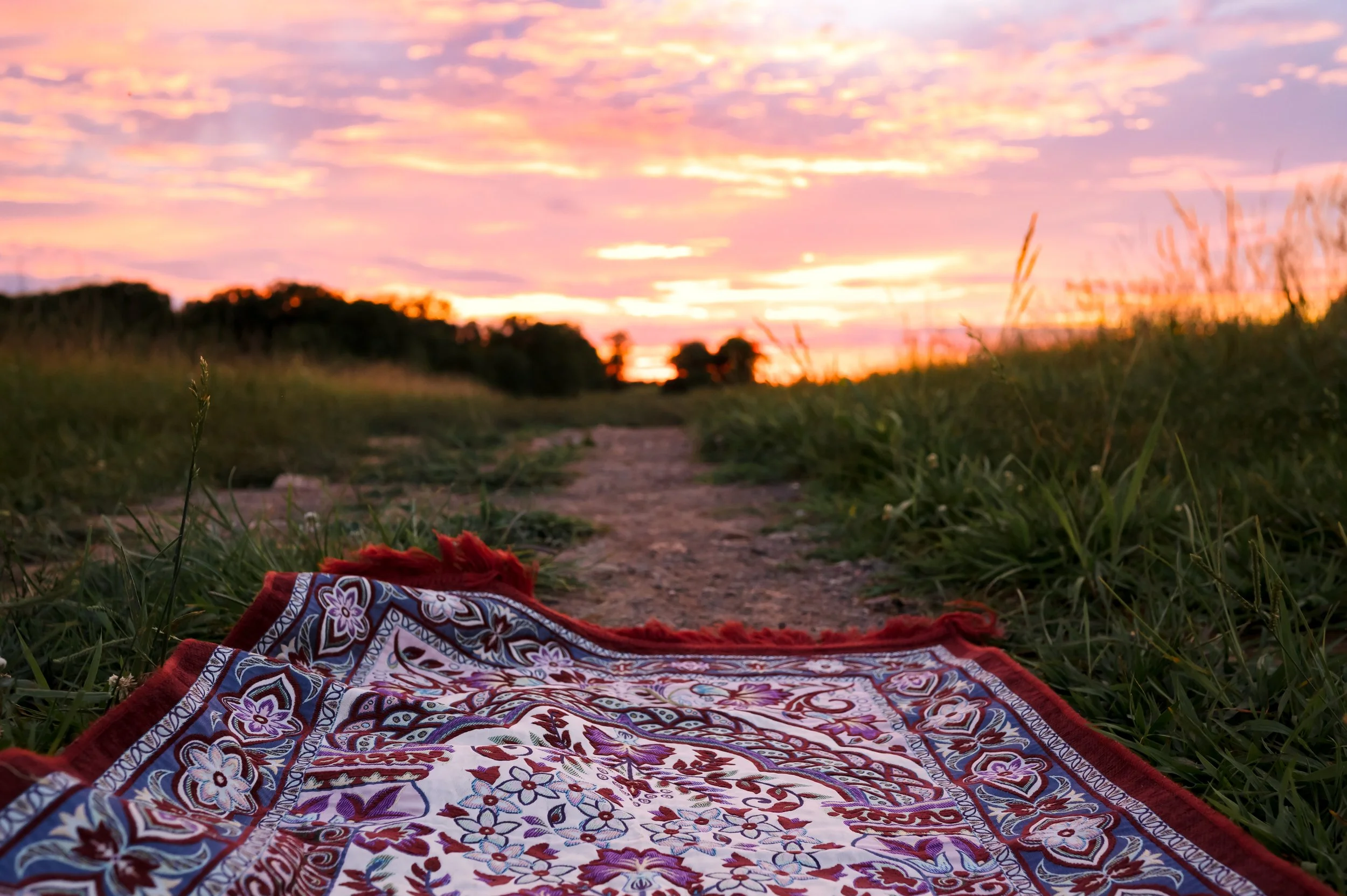 Prayer rug on a path outside facing the sunset