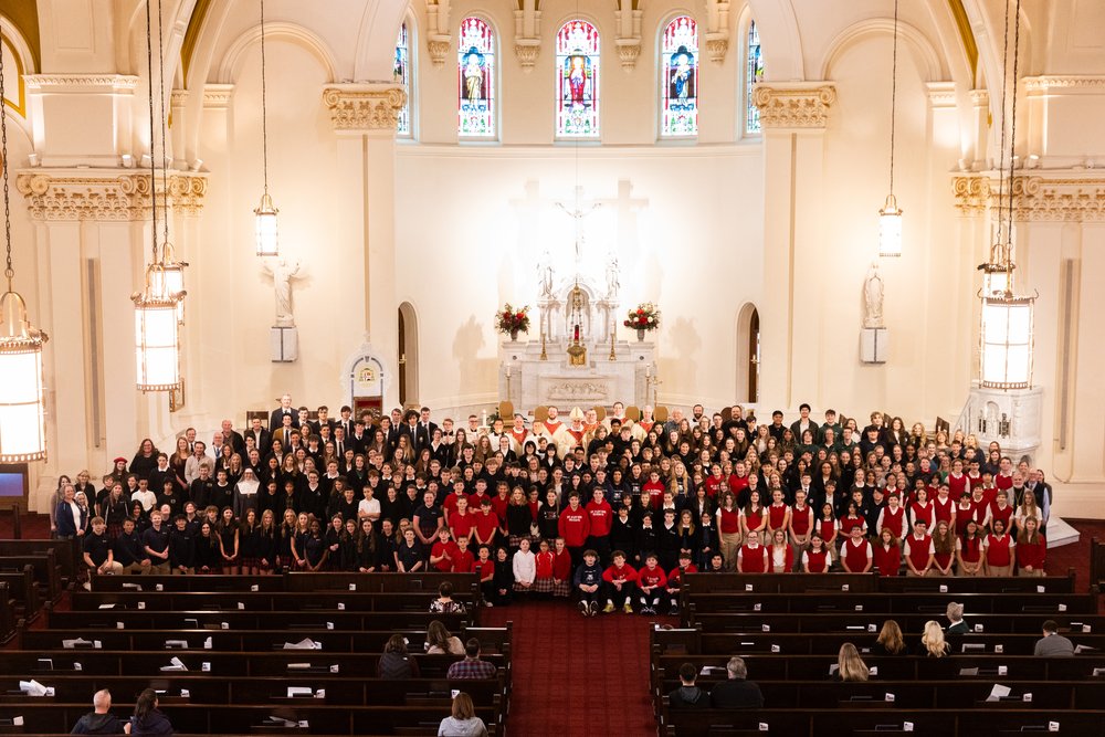 Group photo of all the students, faculty and priests at the all school Mass with Bishop Daly at the Cathedral