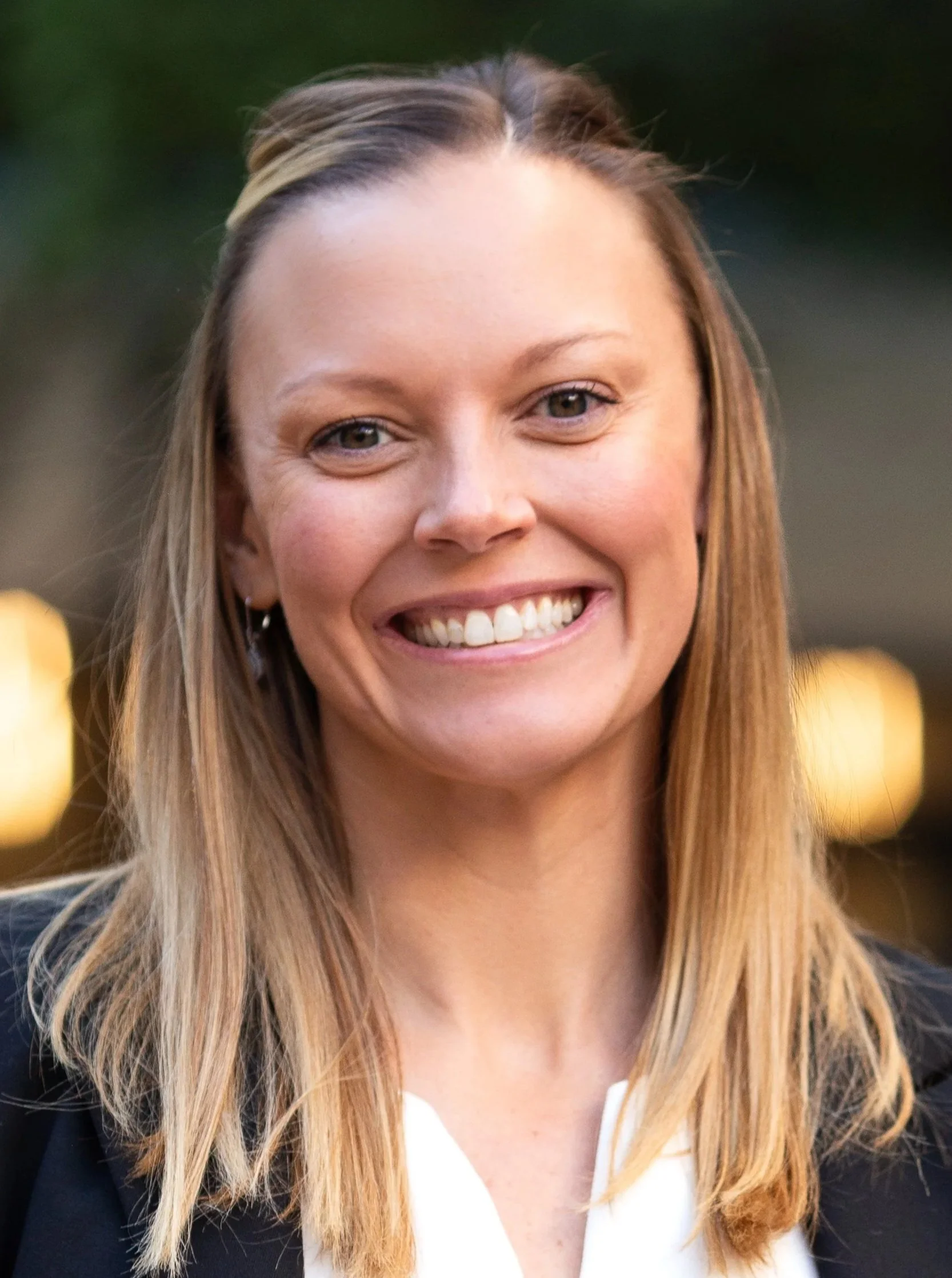 Jamie Paine, cofounder and managing partner of Thrive Family Law in Colorado, smiling in a professional outdoor portrait wearing a black blazer and white blouse.