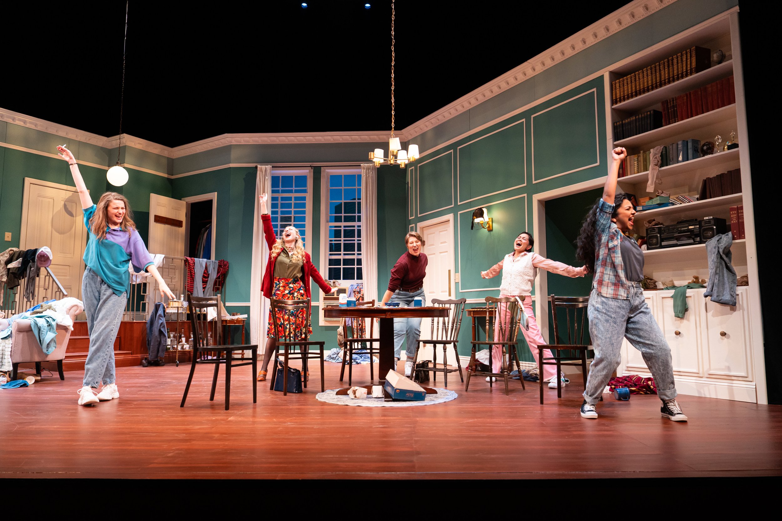 Five students striking a pose in a staged dining room SCU's the Odd Couple Theatre performance. 