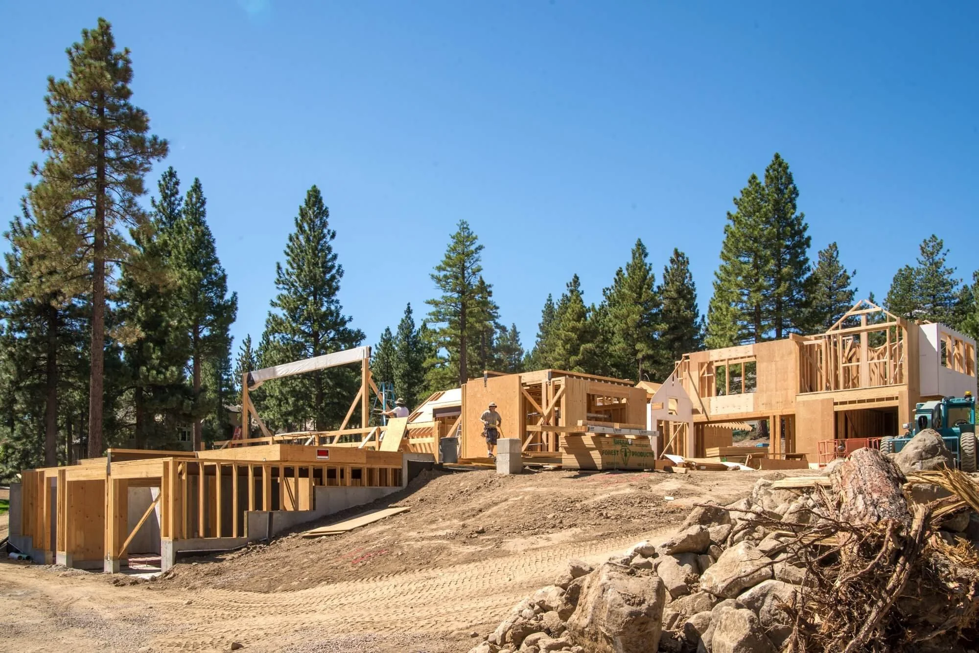 Framing stage of construction on a custom home build in Montreux in Reno, Nevada. Blue skies and pines in the background