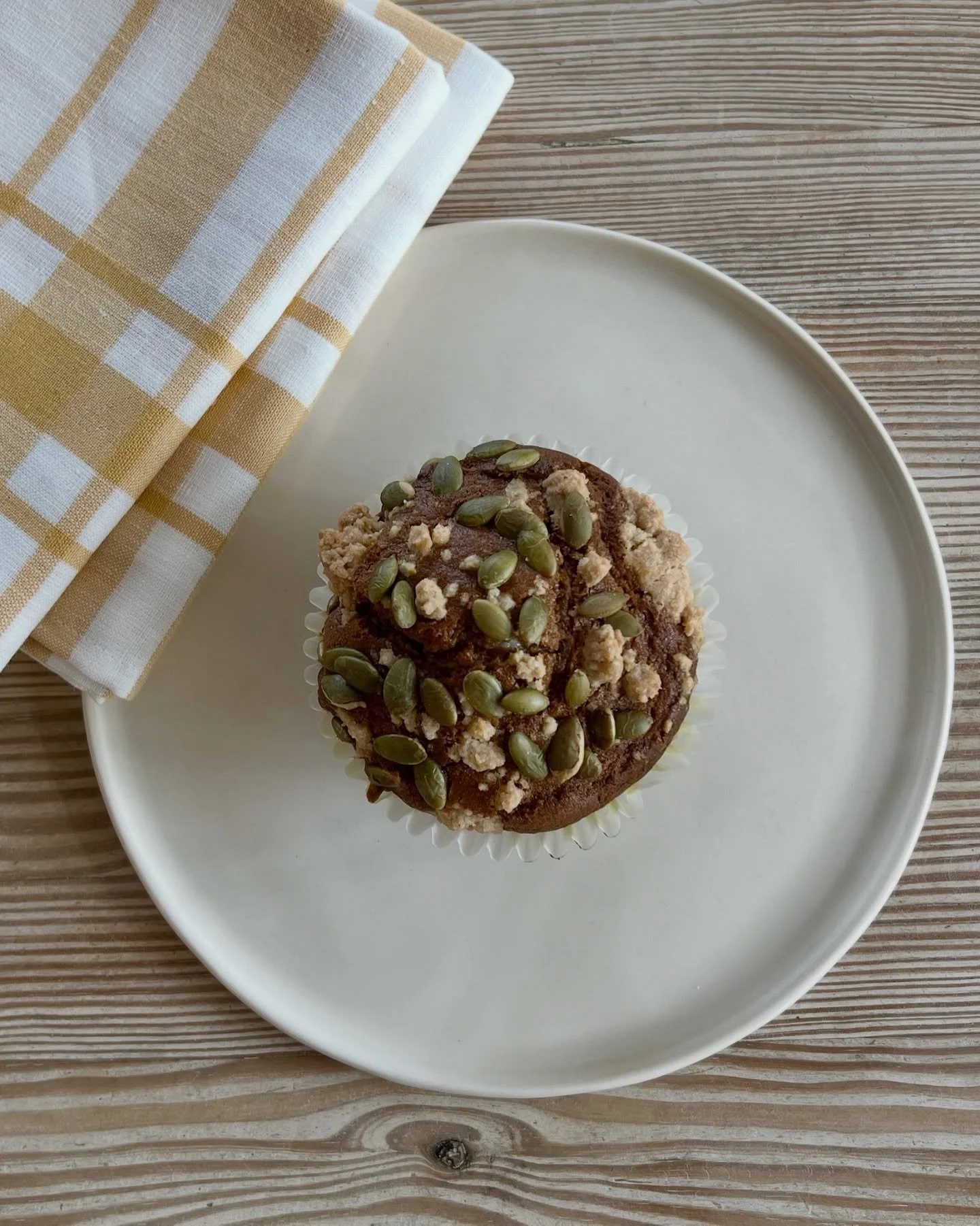 Fall flavors - our new pumpkin muffin has a spot of cream cheese inside &amp; a toasted pumpkin seed crumble on top! 🍂