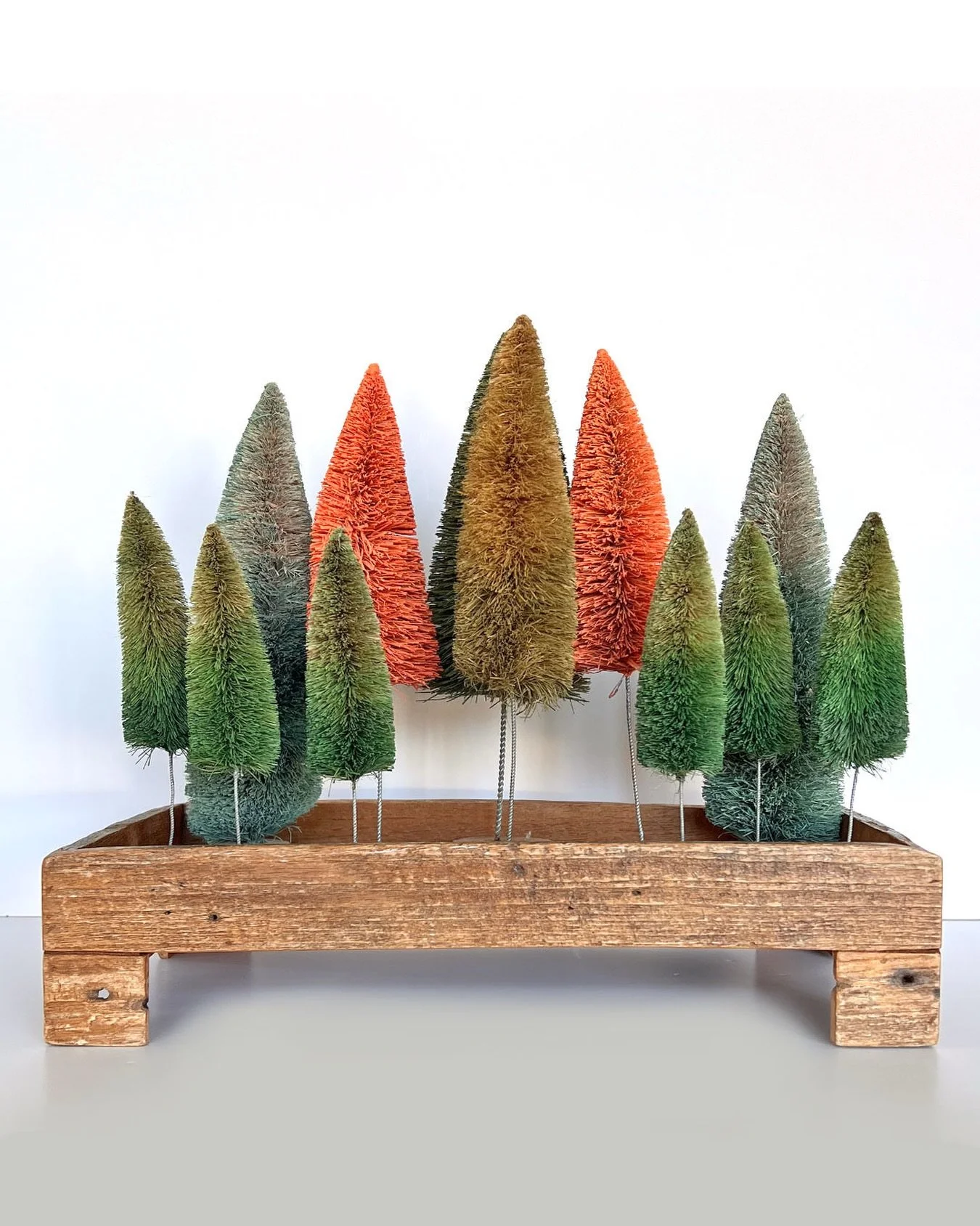One of our favorite ways to decorate for the holidays - A collection of bottle brush trees in all different shades of the season 🌲