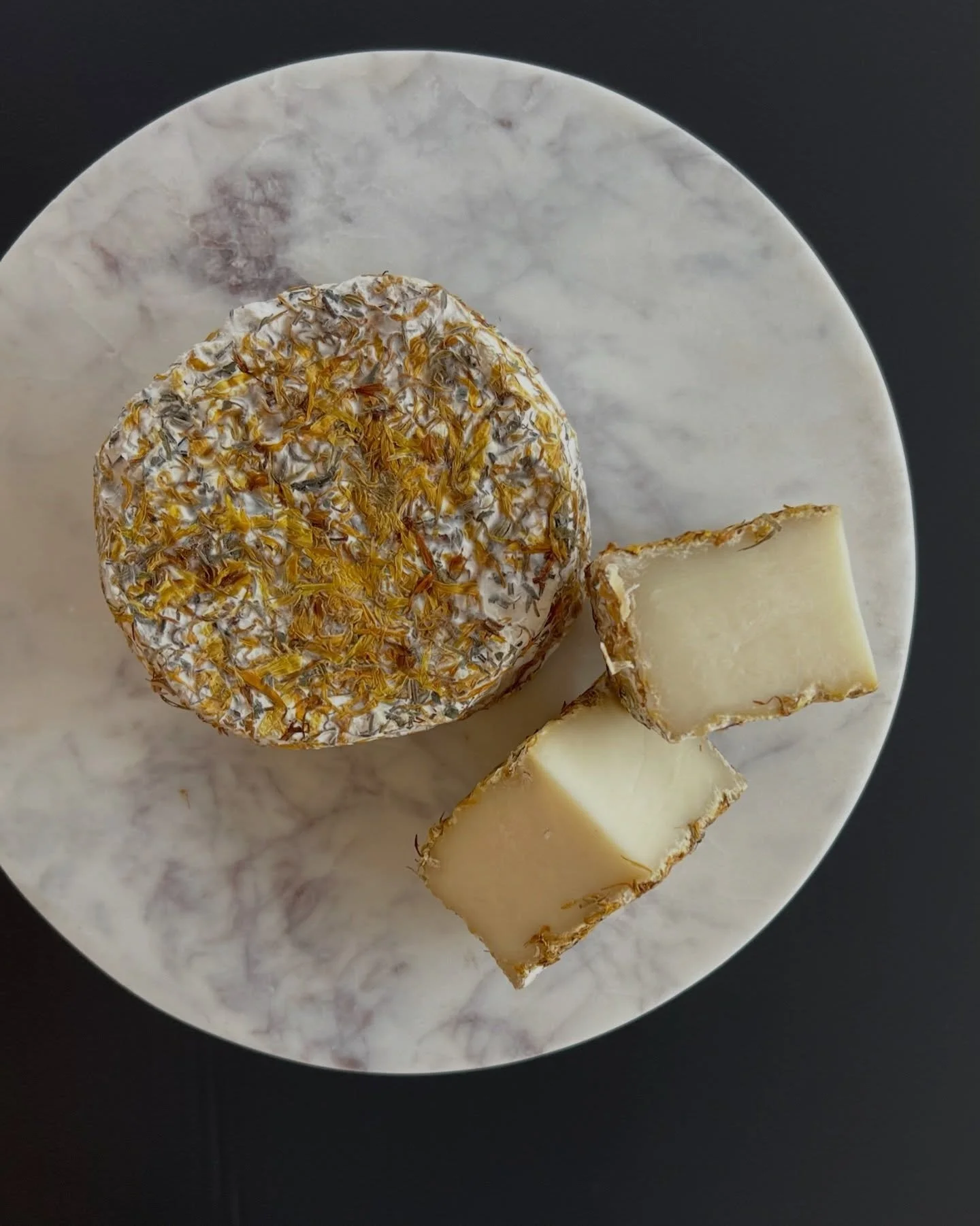 Julianna, a pasteurized goat cheese, is rolled in a mixture of Herbes de Provence, pink peppercorn, safflower, and calendula - and makes an excellent pairing with olives &amp; cured meats!