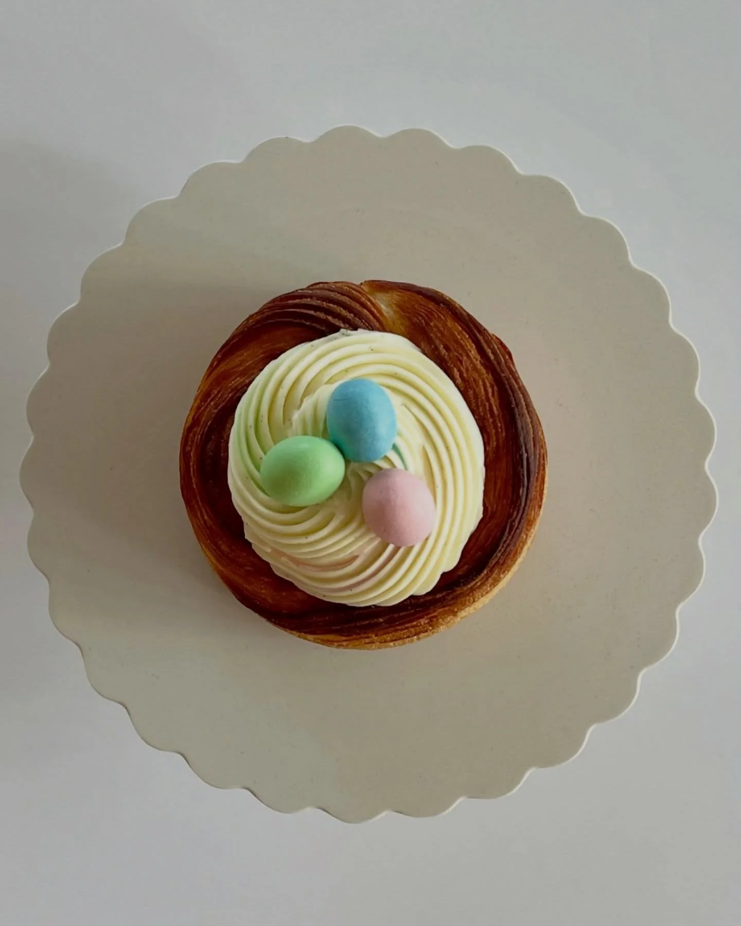 A croissant basket, filled with lemon curd &amp; vanilla cream and topped with, you guessed it, chocolate eggs!.. 
In the bakery case this week.