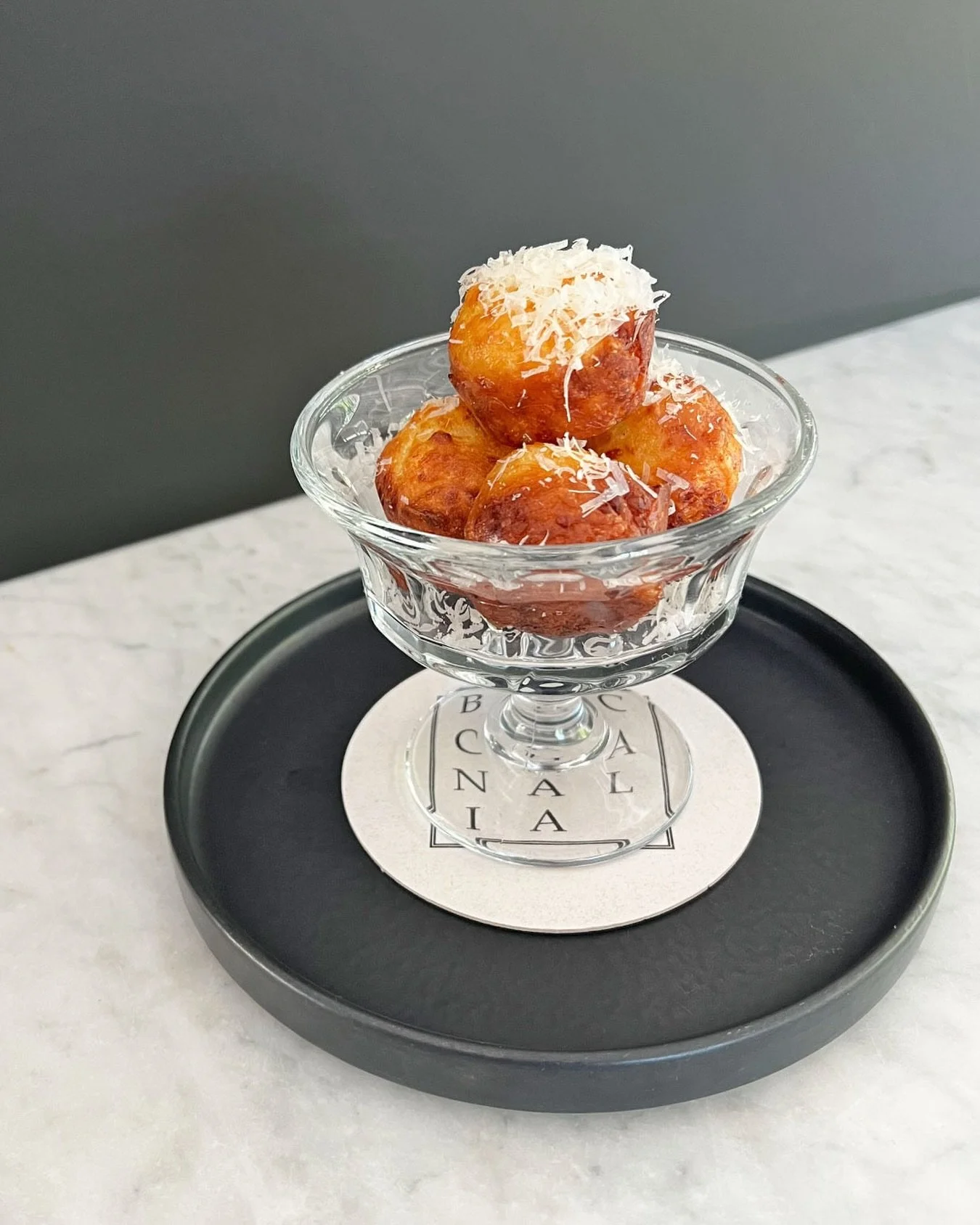 The first treat of the evening &mdash; guests at Bacchanalia are greeted with our P&atilde;o de Queijo, a traditional Brazilian cheese bread.