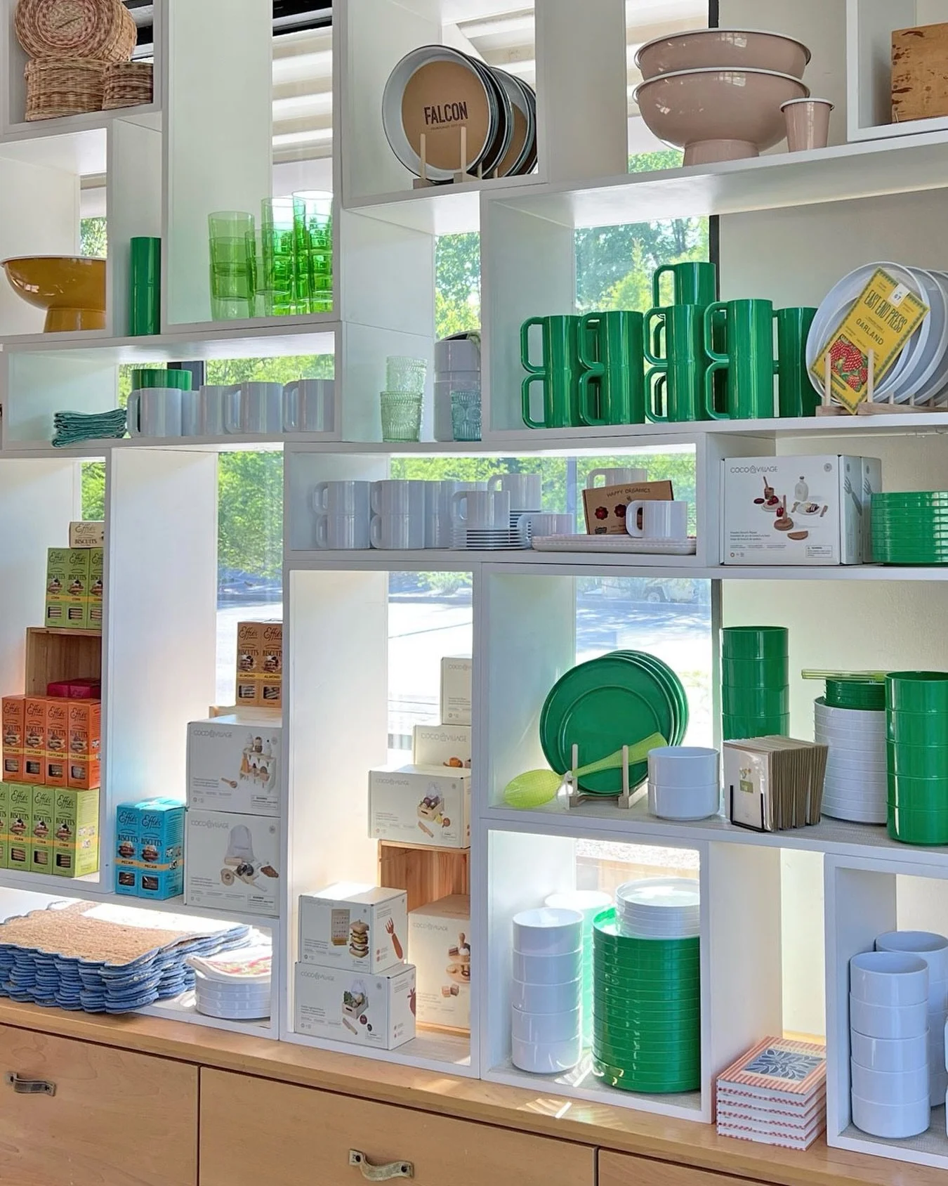 Shelves lined in green and white, layered with pieces that feel fresh, easy, and full of color! 

Shop our @hellerfurniture collection online &mdash; link in our stories