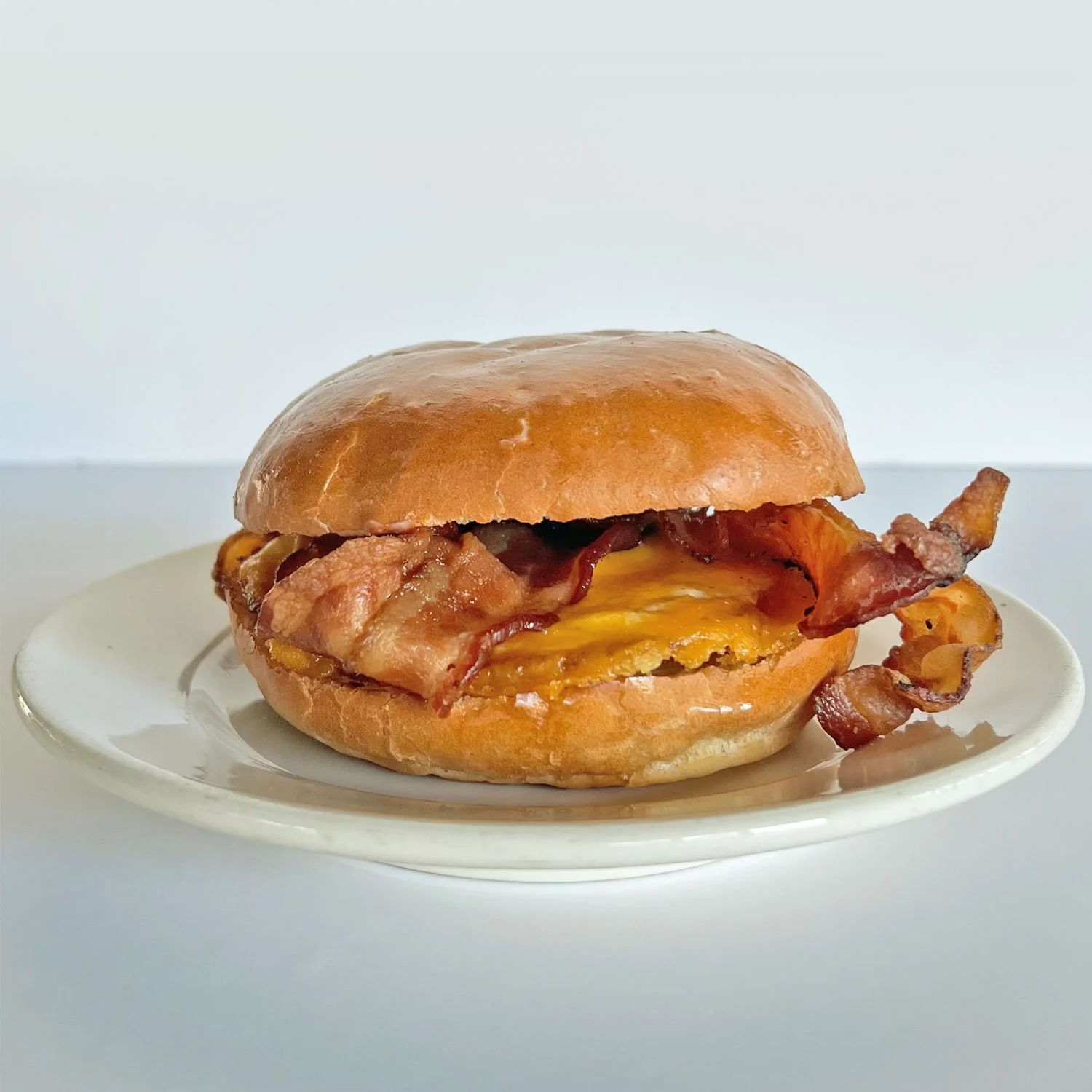 BREAKFAST: Fried Egg, Bacon on a Soft Roll with Cheddar