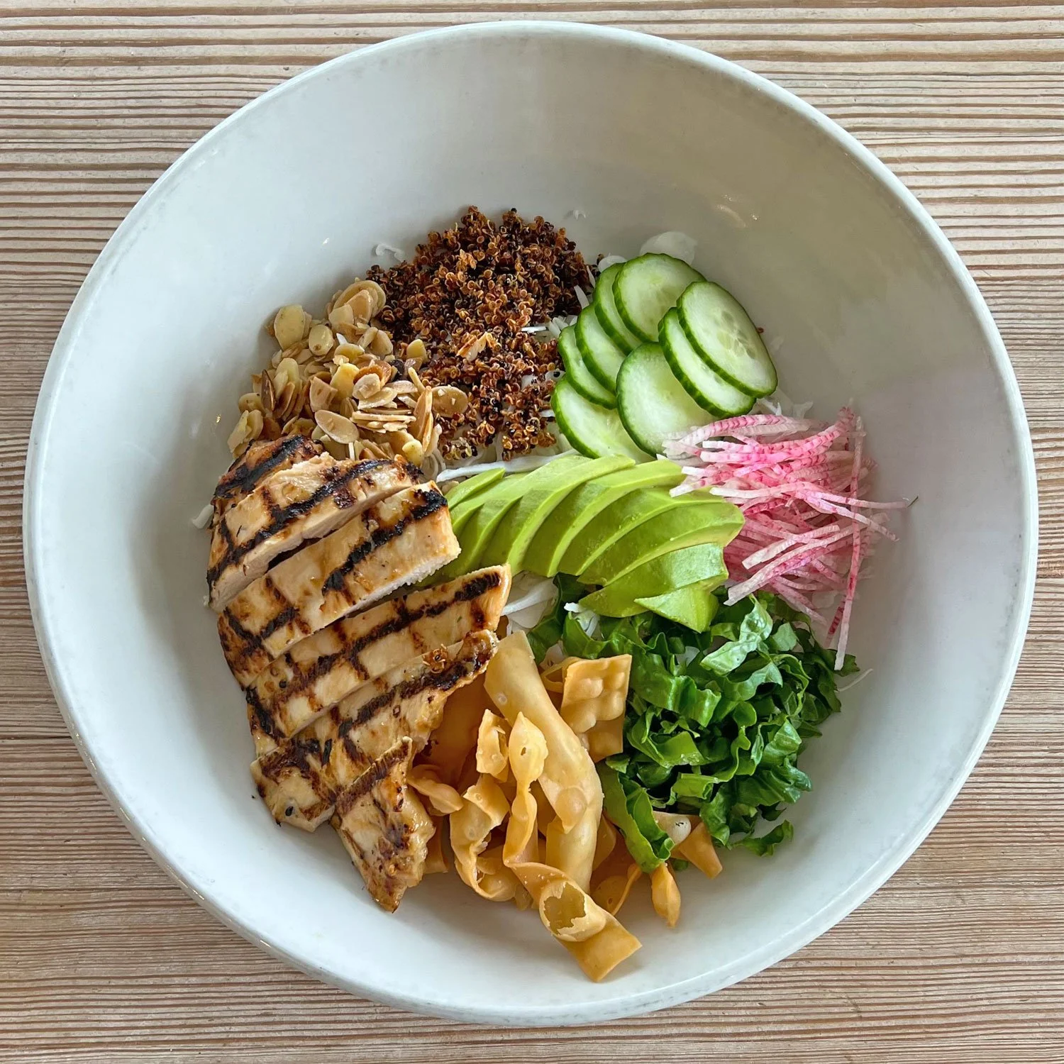 BOARDS + BOWLS: Grilled Chicken Salad with Avocado, Cabbage, Cucumber, Crispy Strips, Toasted Almonds, Quinoa and Sesame Ginger Vinaigrette