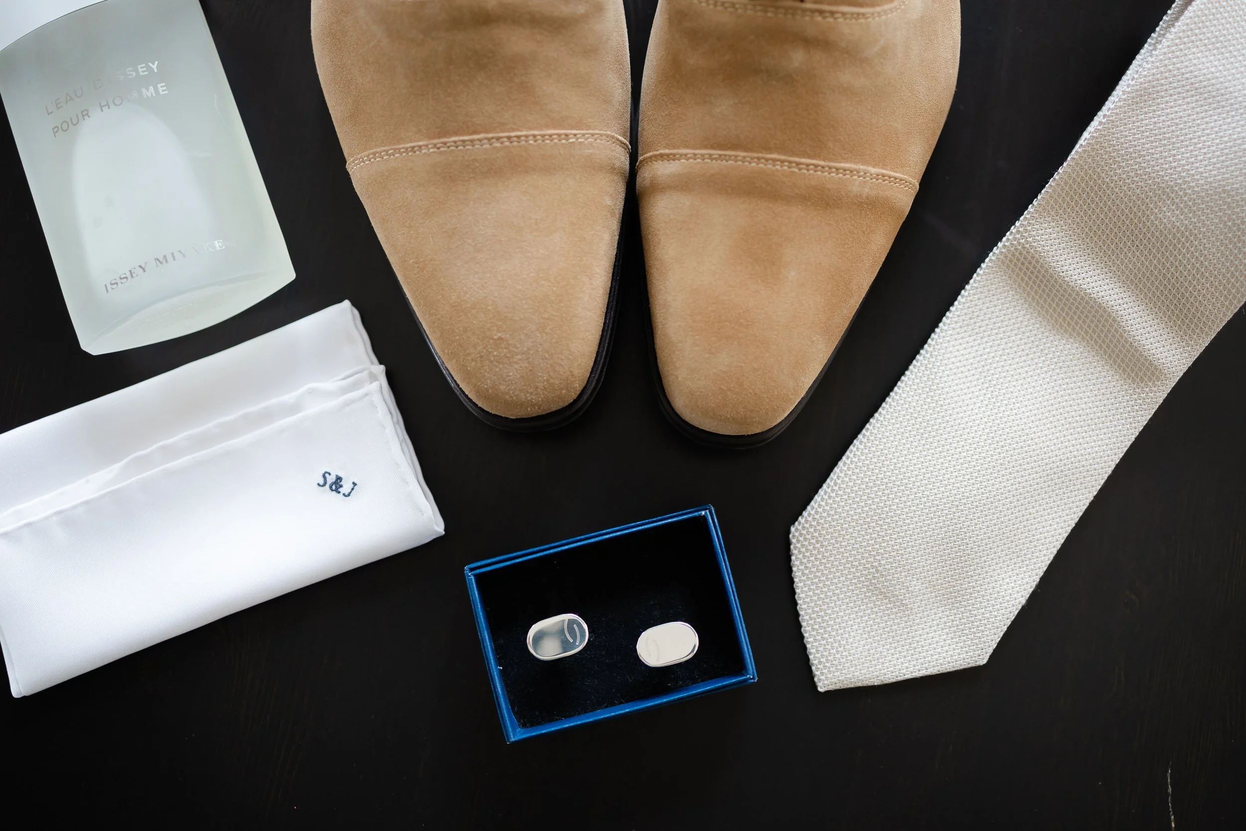 rouwschoenen, parfum, manchetknopen en stropdas als styling details van de bruidegom op de trouwdag