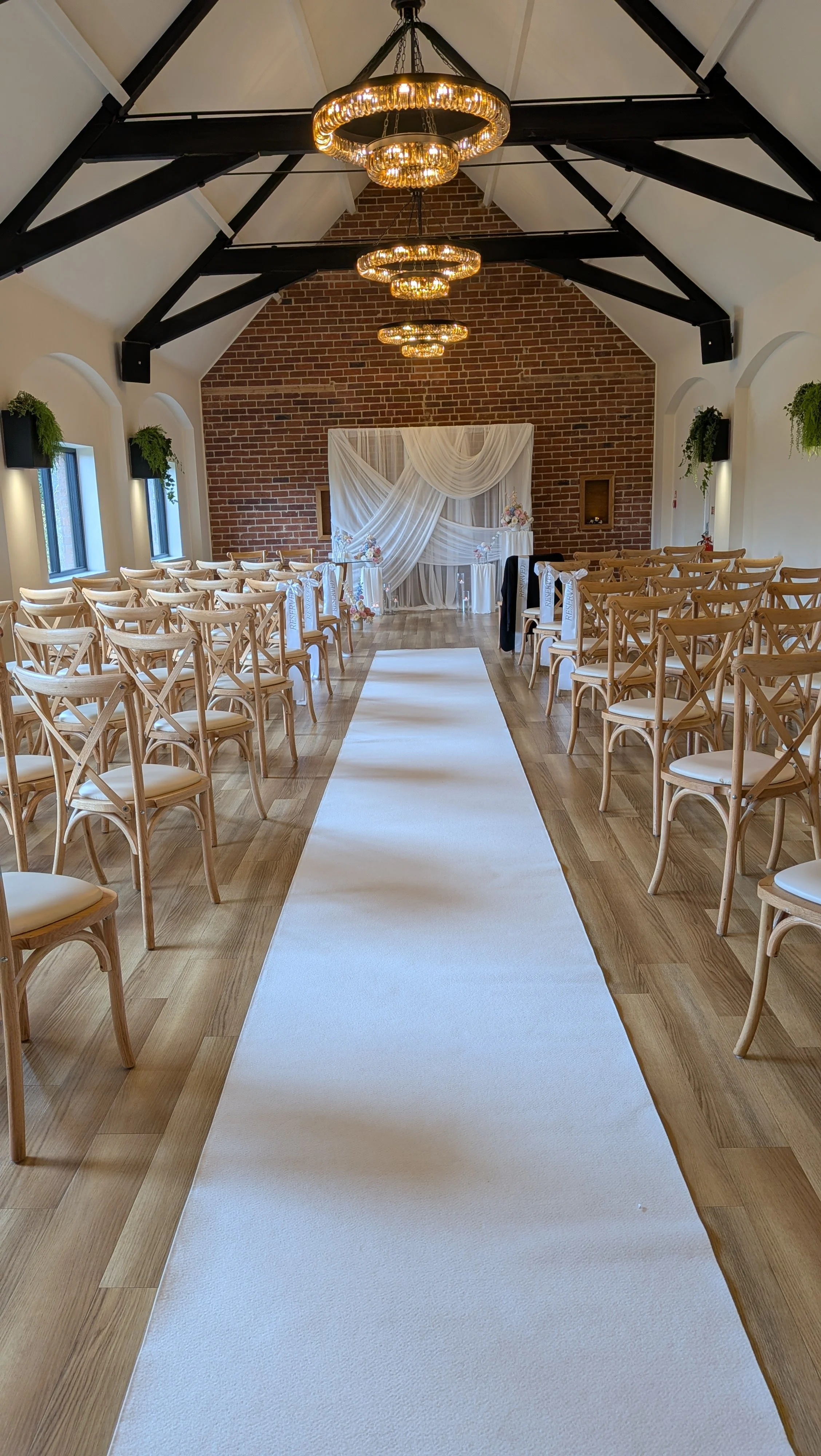 Wedding ceremony aisle and seating inside Whistle Barns in Derbyshire