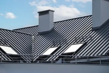 Contemporary roof design with metal panels and skylights.