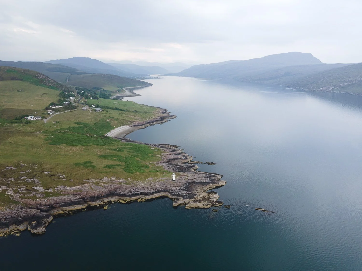 A breathtaking view of a lighthouse perched at the edge of a sea.