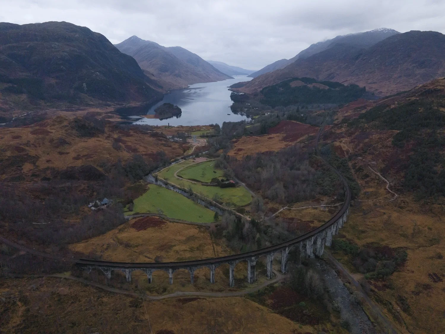 A scenic view of Glenfinnan viaduct and loch Shiel in the distance.