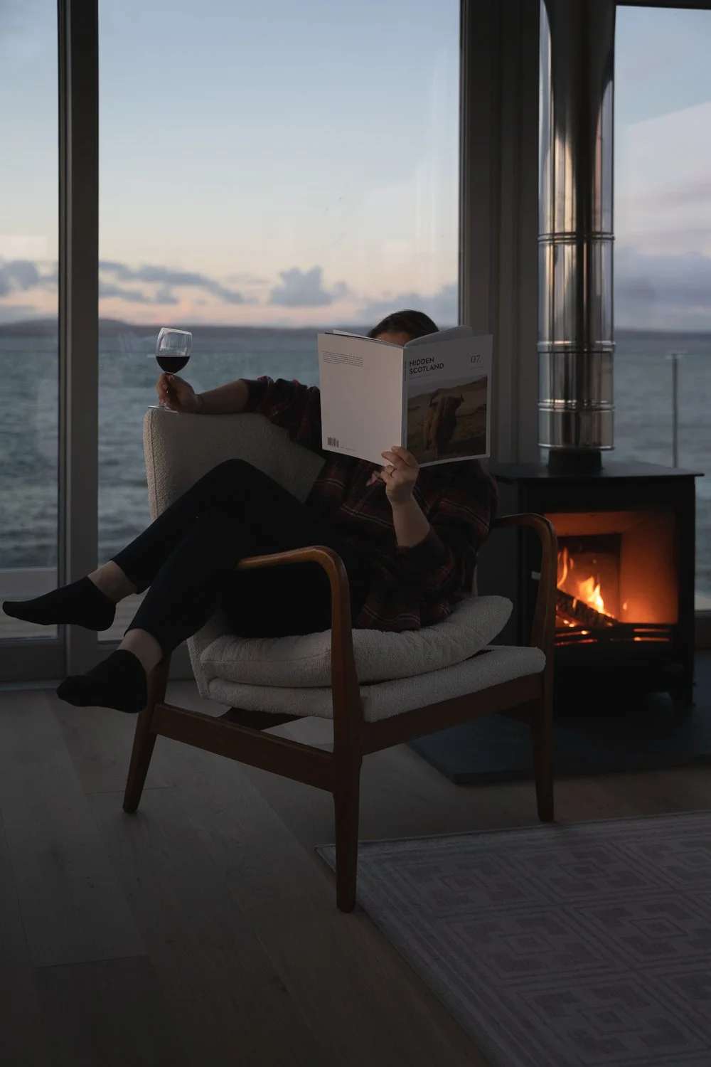 reading a magazine by the fire.jpg