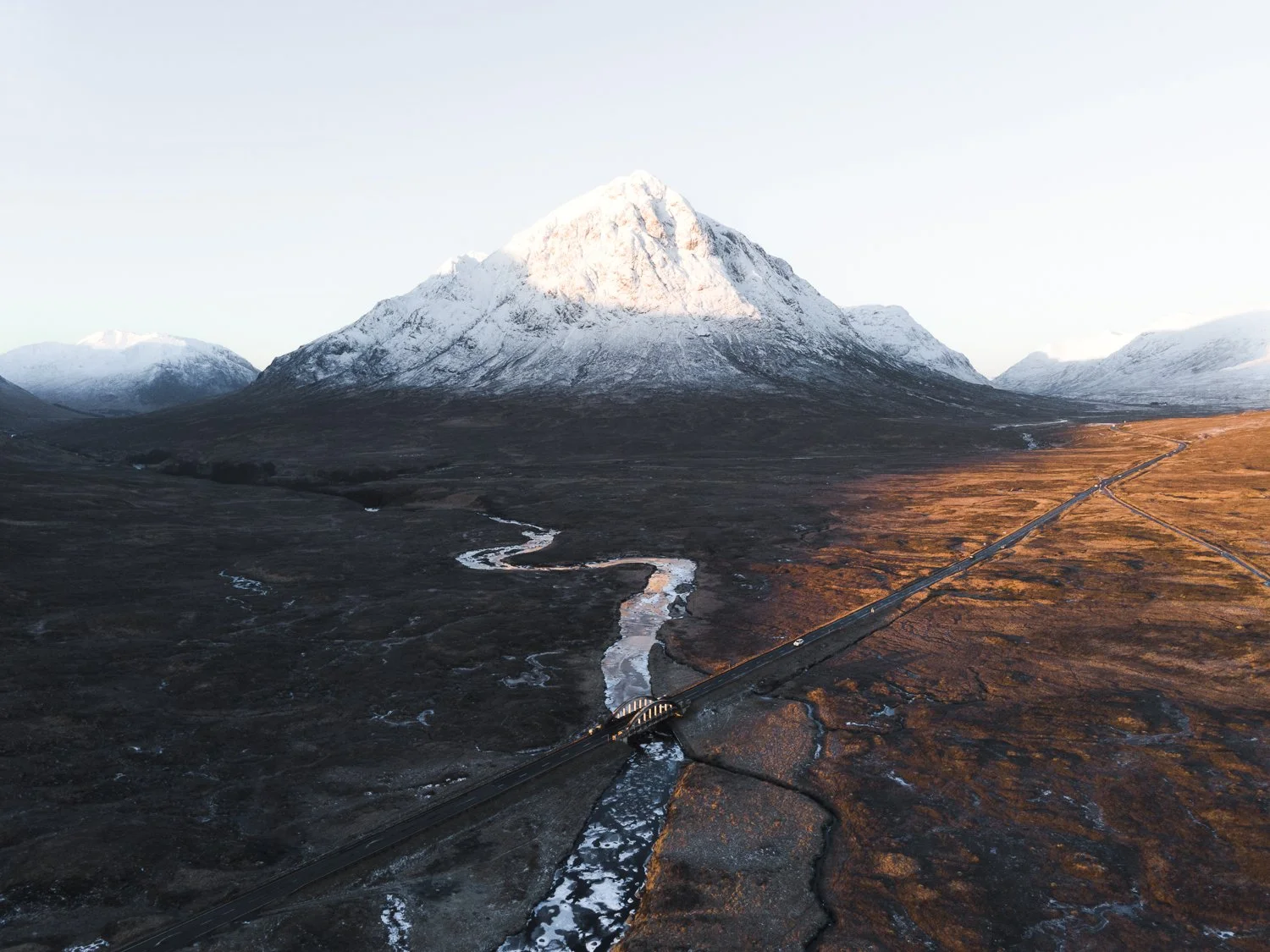 Iconic aerial view of a Glen Coe bridge with Buachaille Etive More in the background.