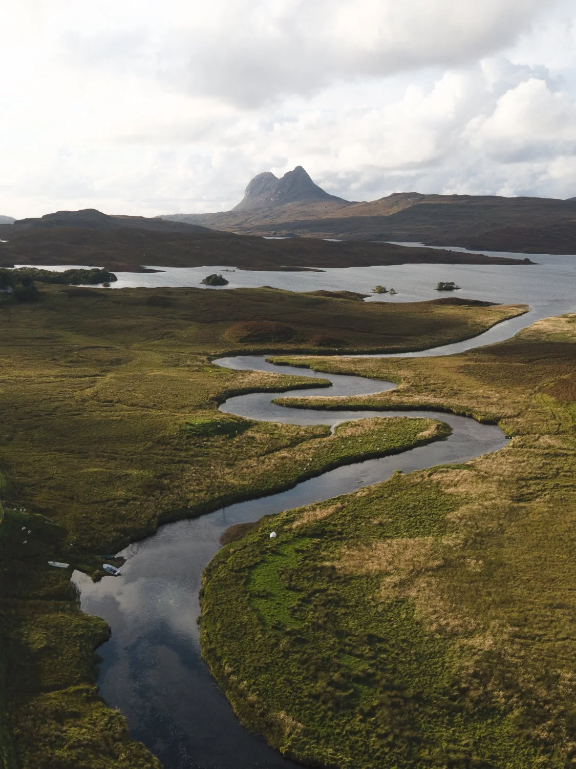 a winding river with a view of Suilven.
