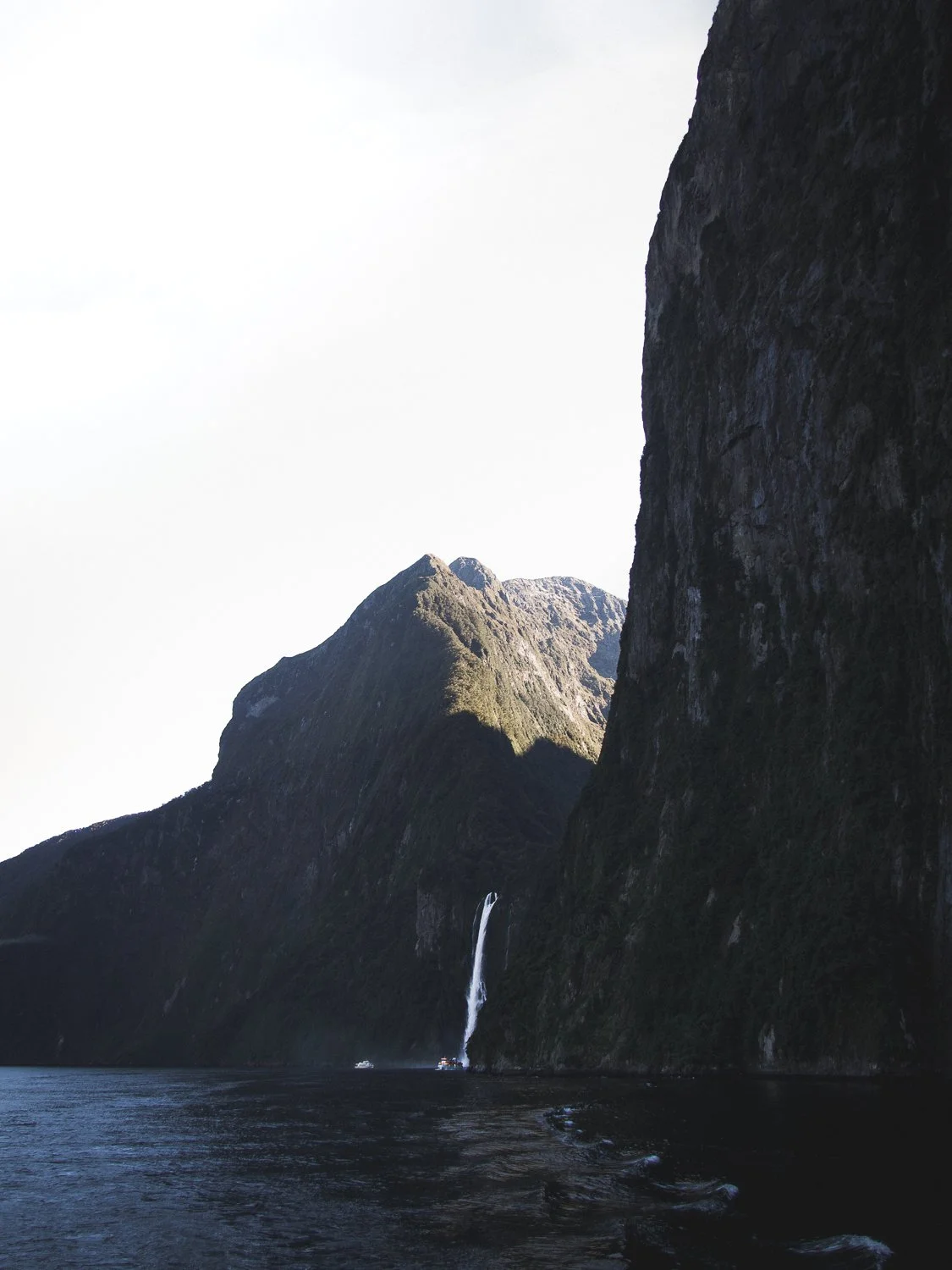 A scenic view of a waterfall in Milford Sound.