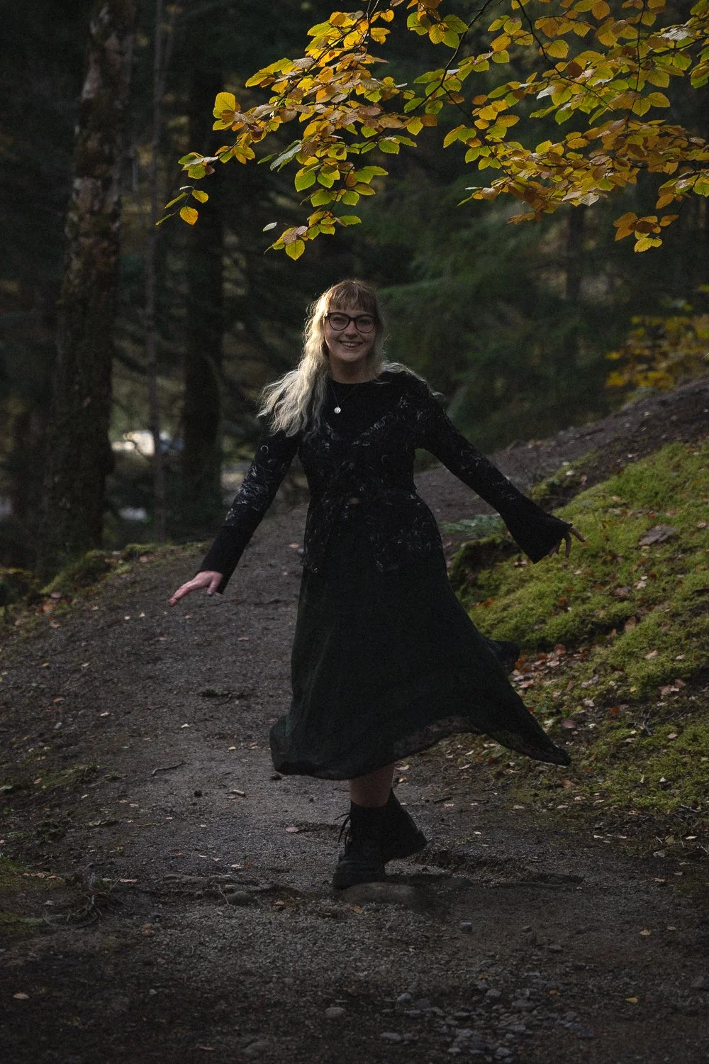 Blonde model in black dress smiling at the camera.
