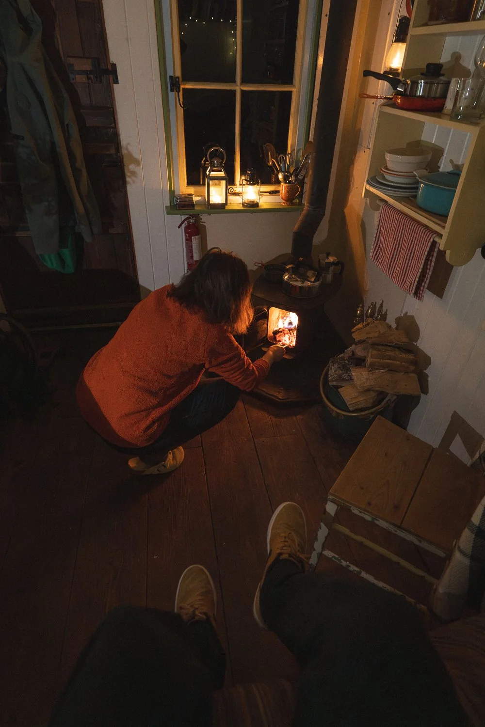 Step inside the shepherd's hut and warm up by the charming wood-fired stove. Perfect for a cozy, rustic getaway.