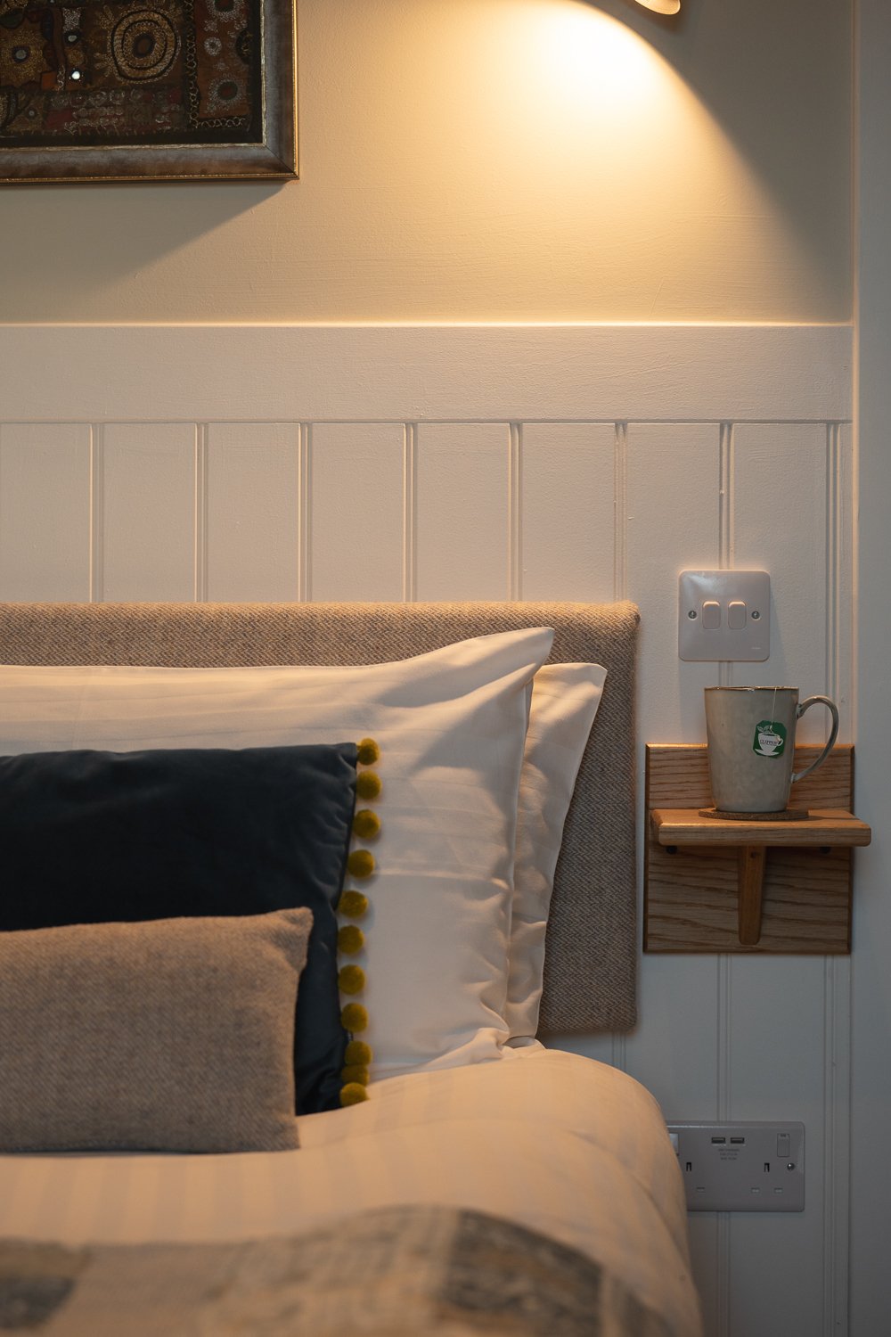 bed close up with tea on the bedside table.jpg