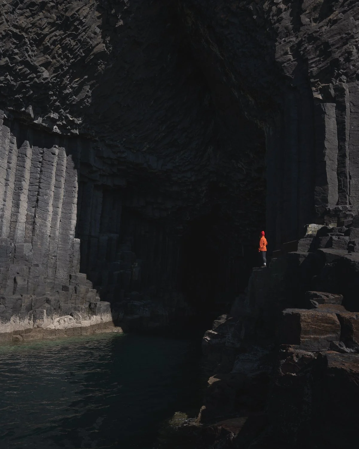 A person staring into Fingal's Cave on Staffa Island.