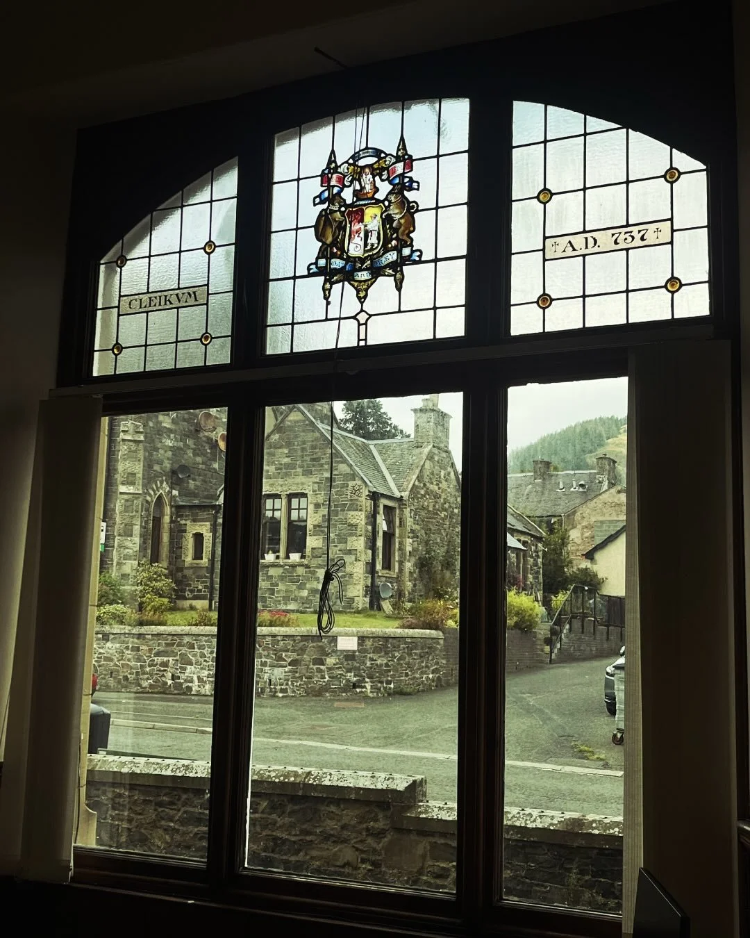 This beautiful stained glass window graces Innerleithen&rsquo;s Carnegie Library- a brilliant symbol of civic pride and cultural heritage. It features the Burgh&rsquo;s coat of arms and the legend of St. Ronan, our patron saint, reminding us of the v
