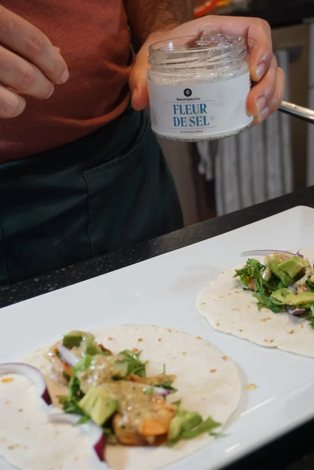 Finishing fresh shrimp tacos with flaky Lebanese sea salt