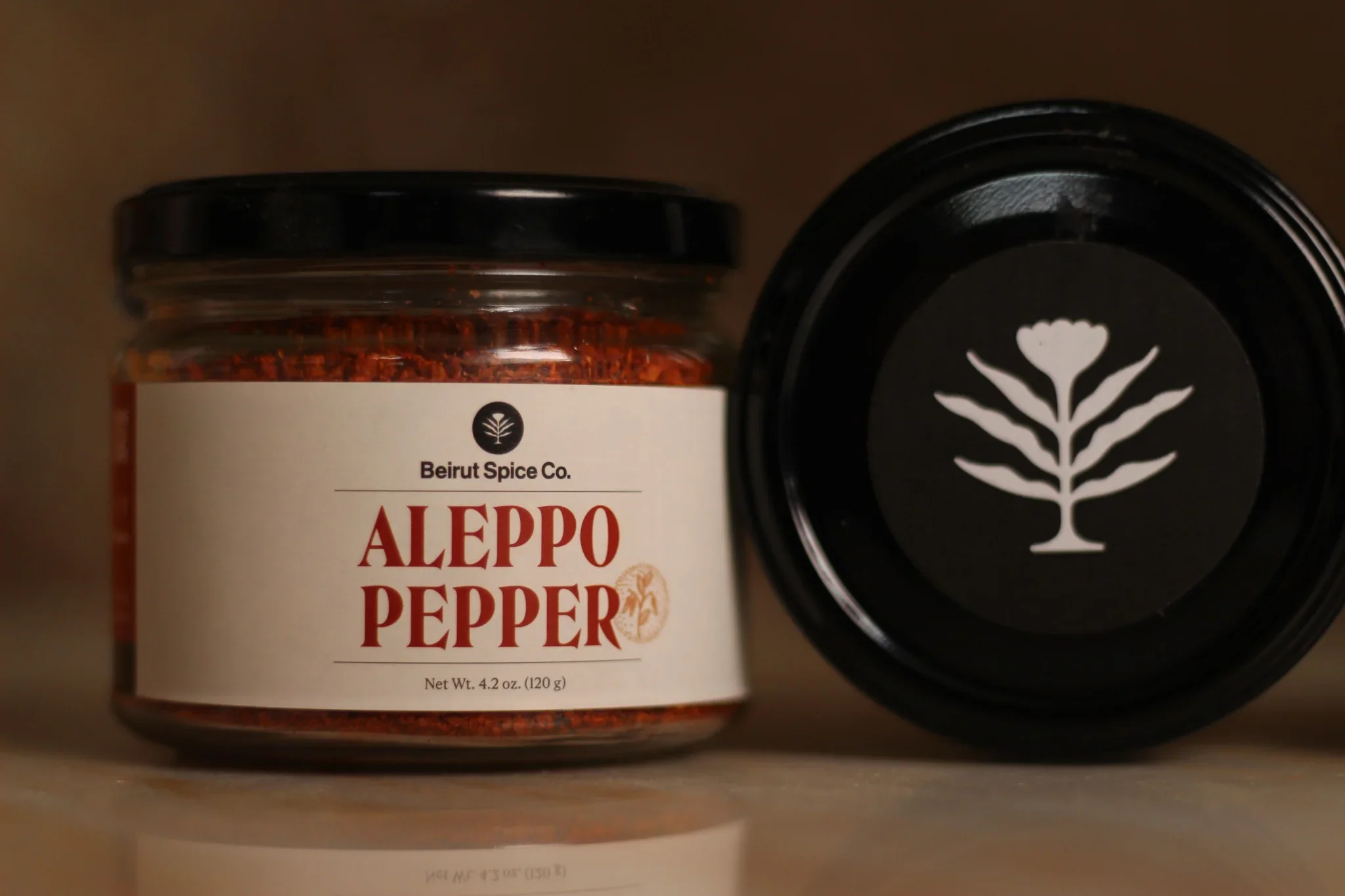 Two jars of smoky, fruity, and earthy Lebanese Aleppo Pepper chili flakes