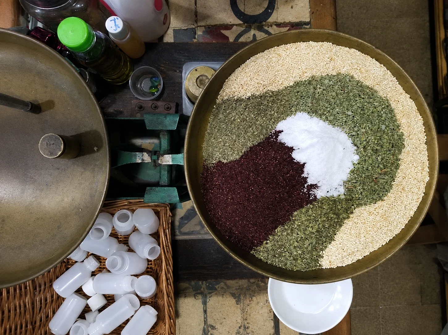 The mixing process of Lebanese za'atar using sumac, sea salt, hyssop, and sesame seeds