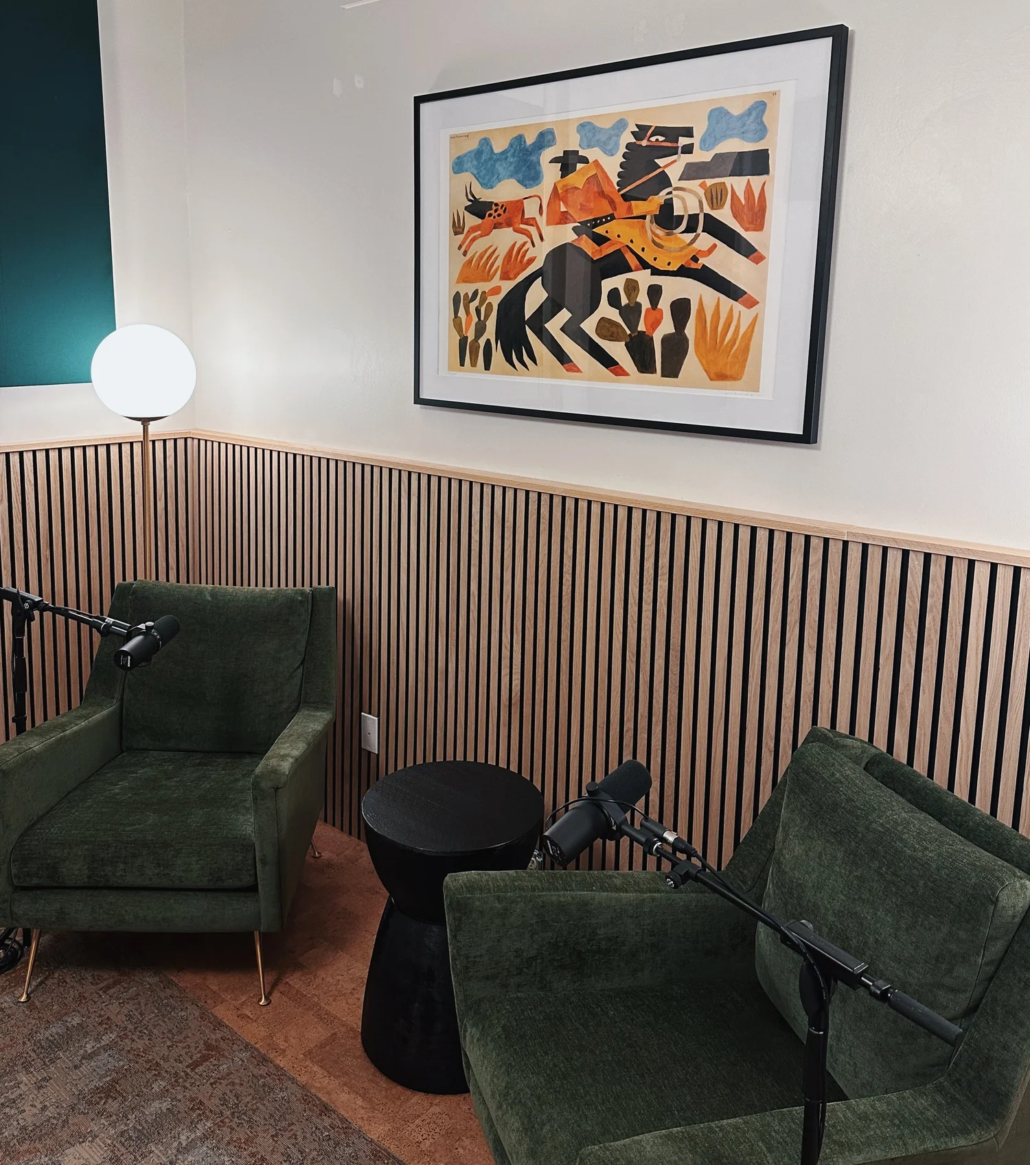 Wax Space podcast studio with two green chairs and microphones