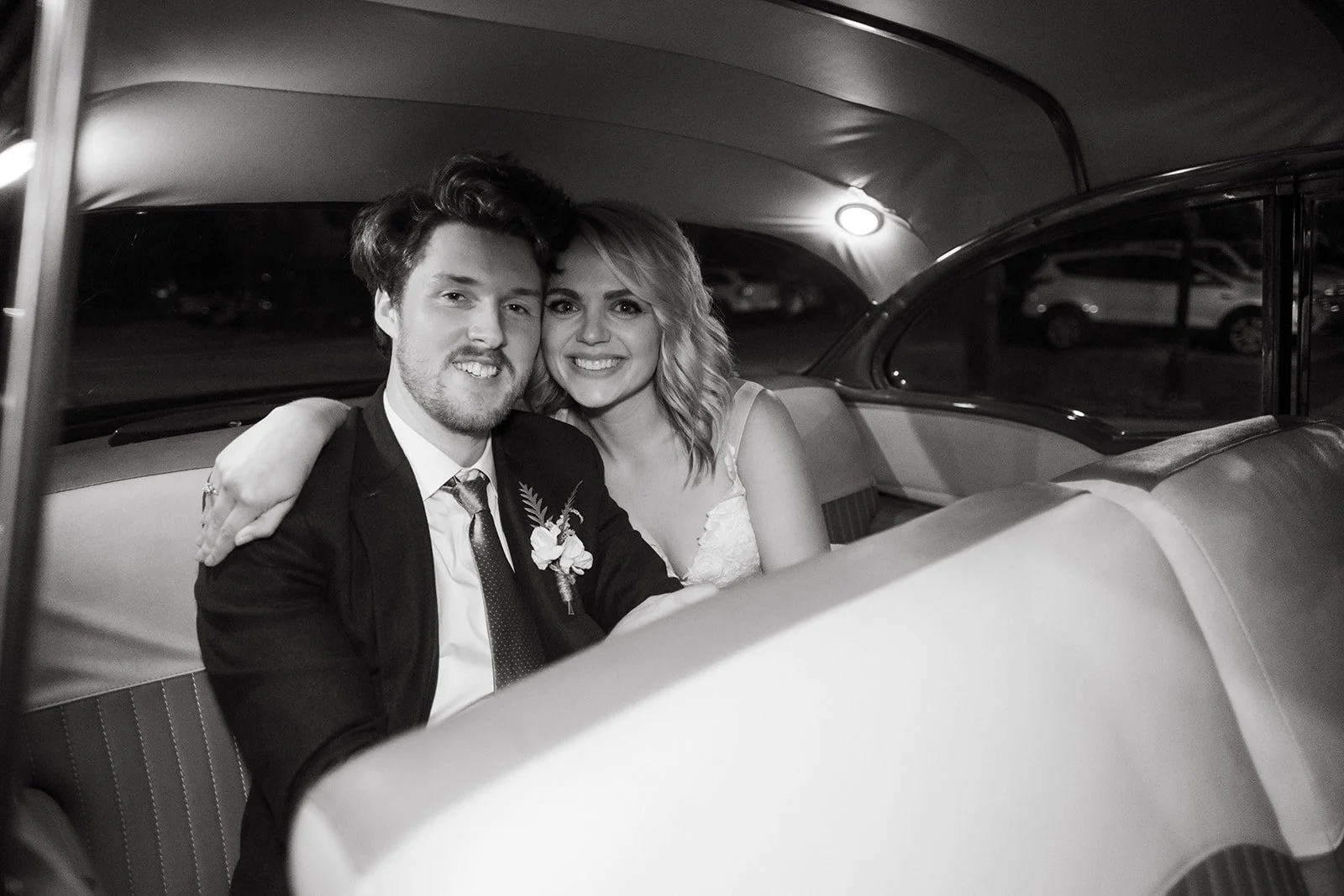 image of happy newlyweds in a classic get-away car by fort worth wedding photographer nick leitzinger