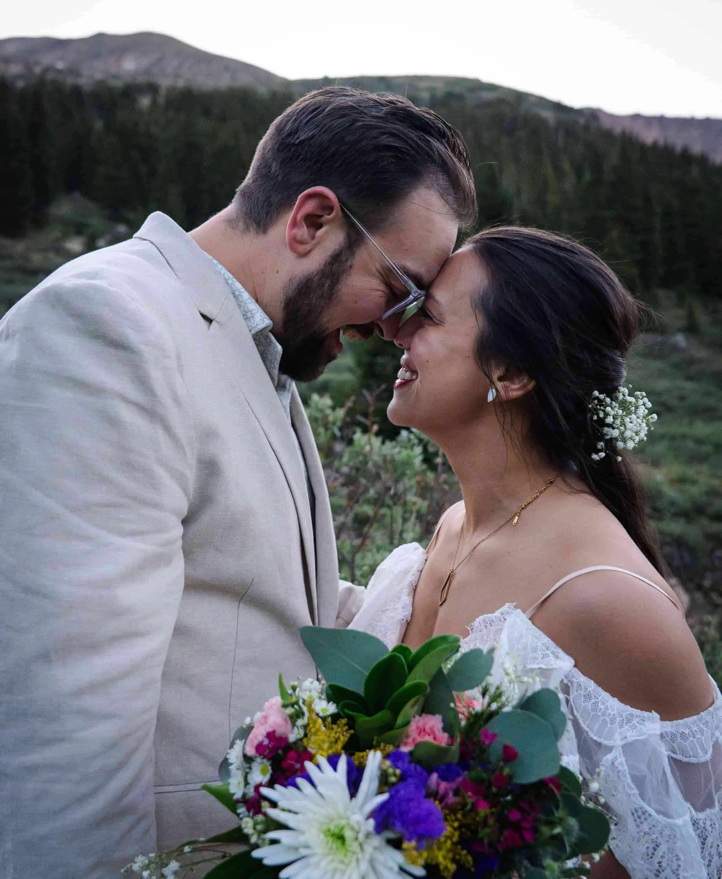 A bride and groom gaze lovingly at each other in the mountains of Colorado.