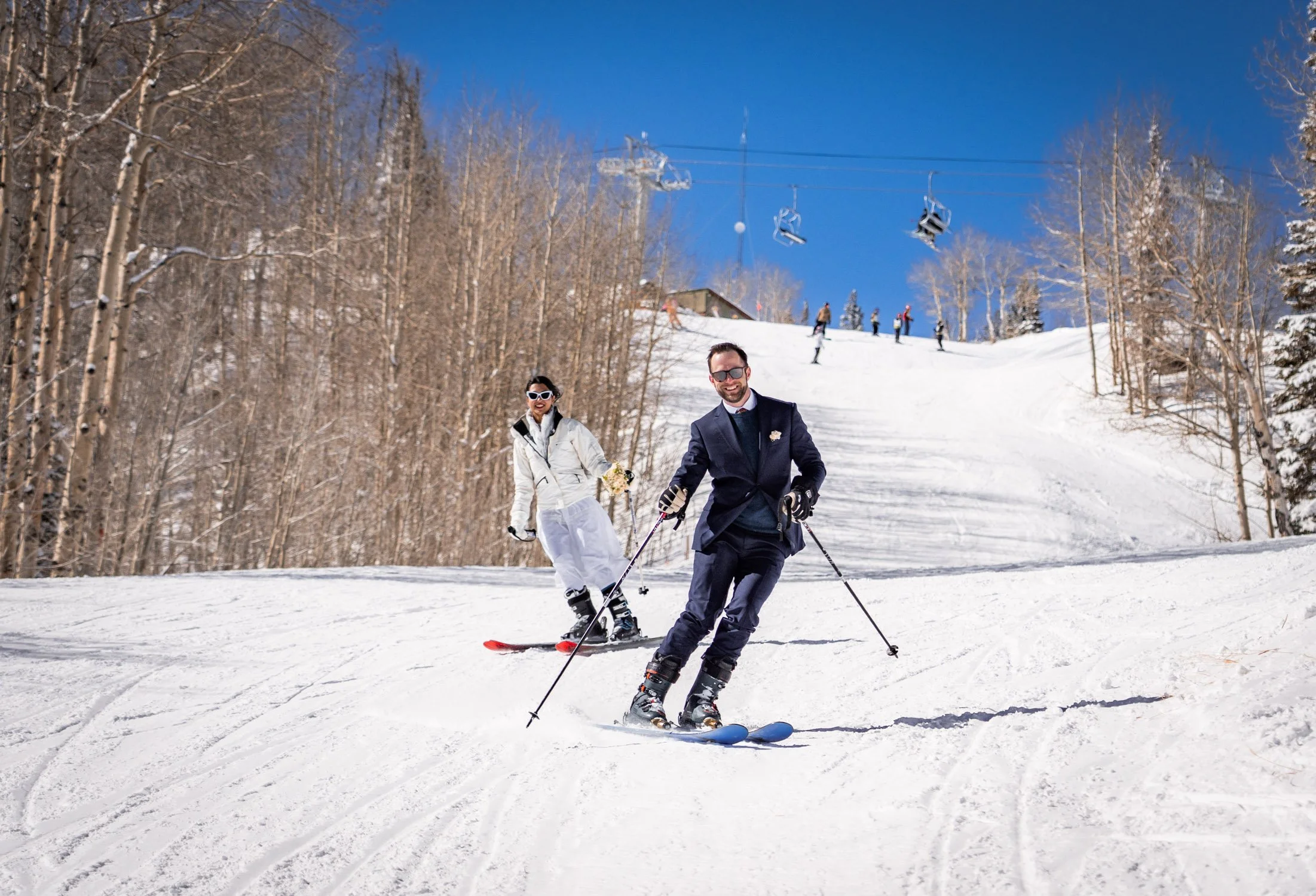 A bride and groom ski down a run together!