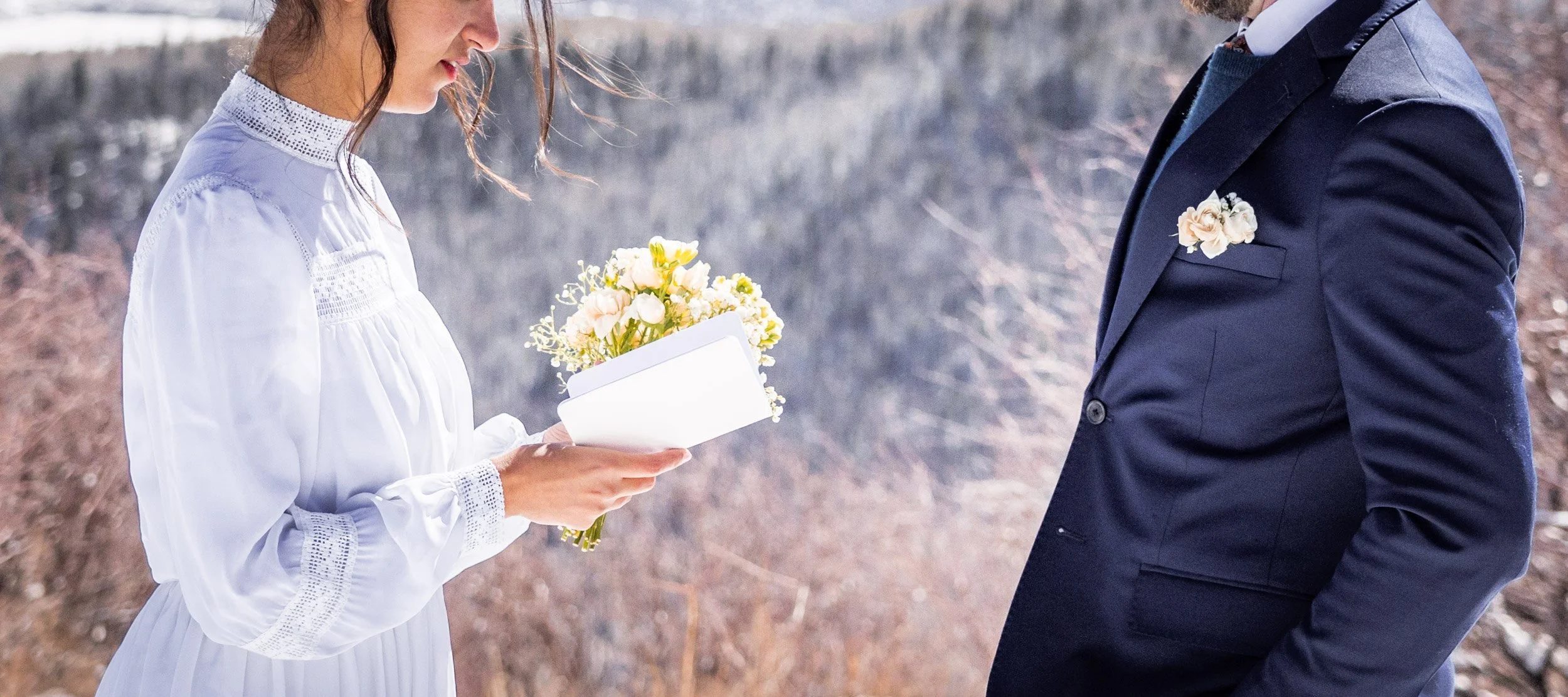 A bride and groom exchange vows on top of a ski resort in Colorado.