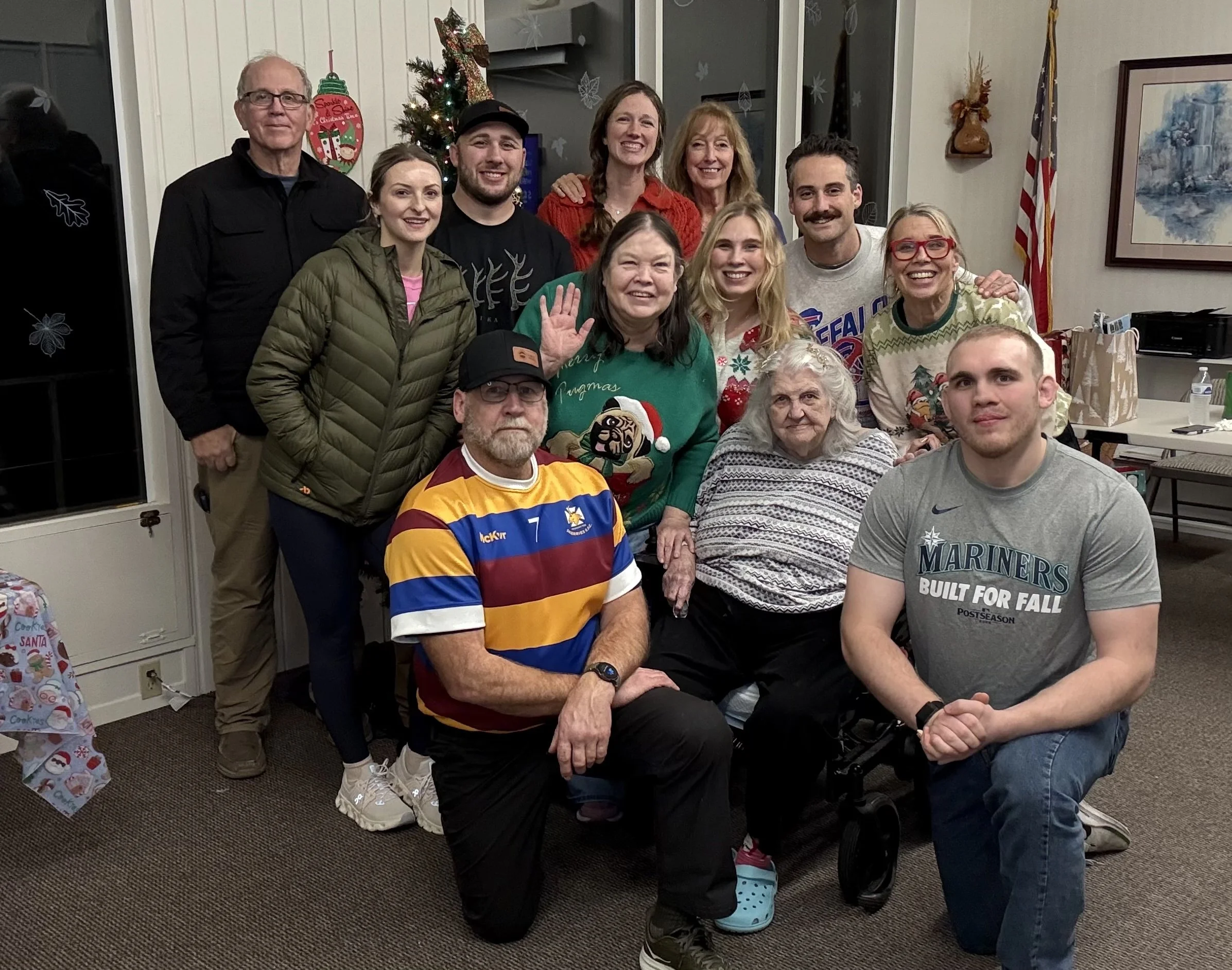 Family gathered together and posing for a photo during Christmas.
