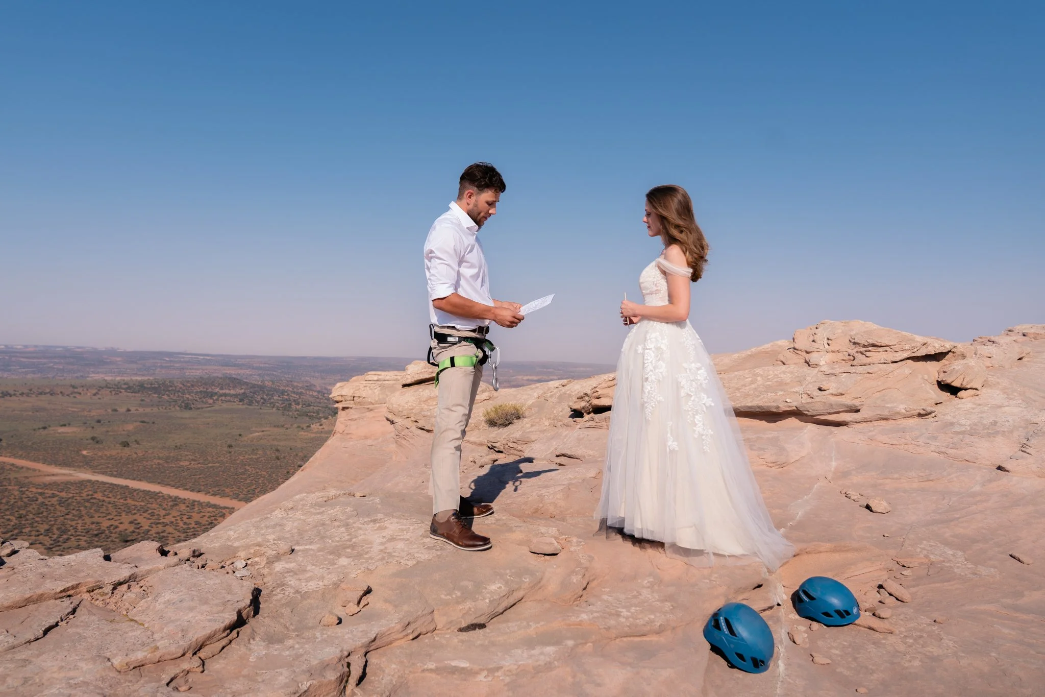 A bride and groom exchange vows on top of a rock in Moab.