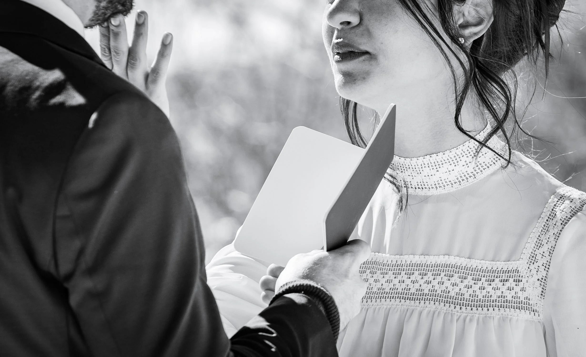 A bride looks lovingly at her groom on a ski hill while exchanging vows.