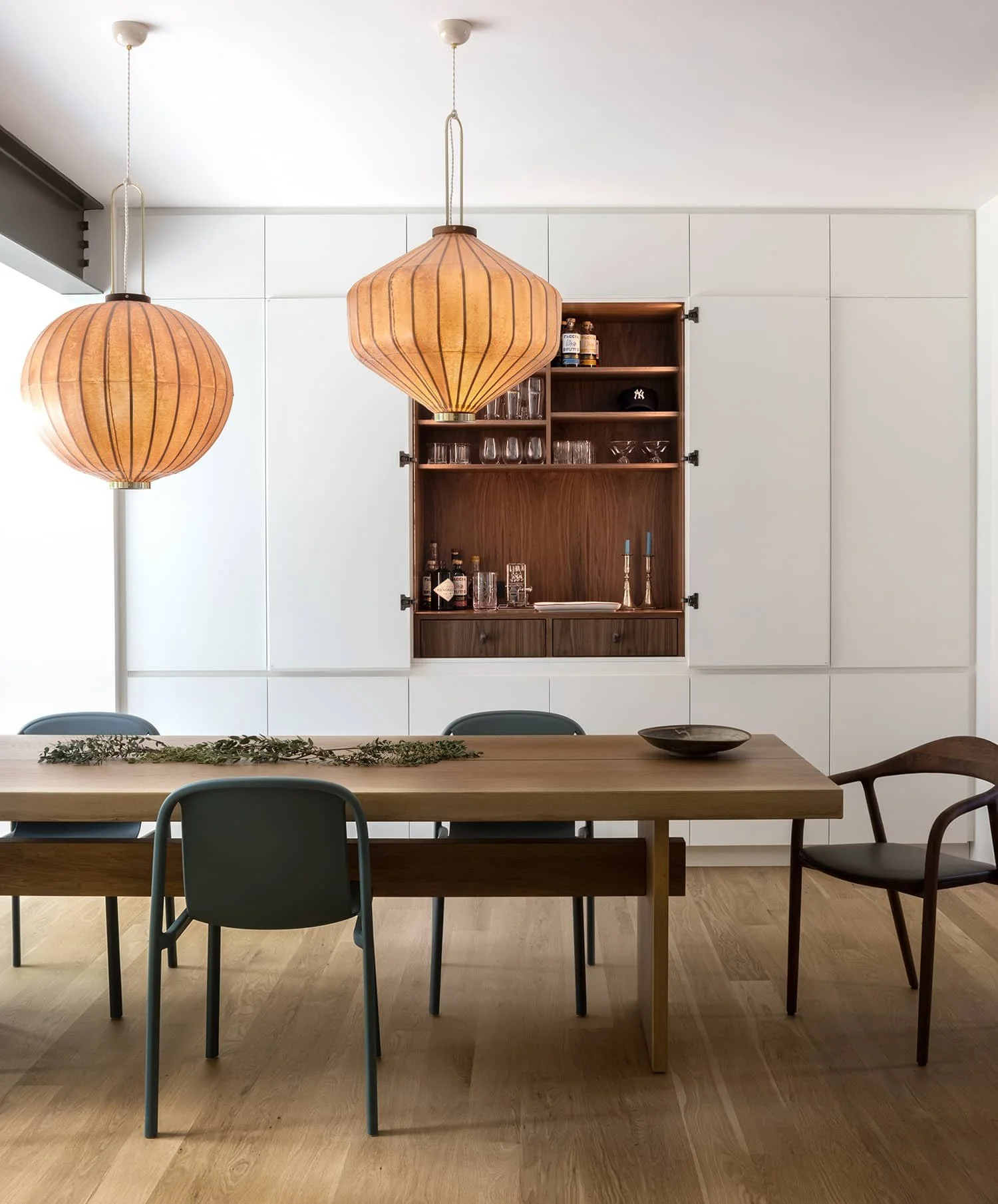 Modern dining room with wall of custom millwork storage and bar, designed by Fowlkes Studio in Kalorama Washington, DC
