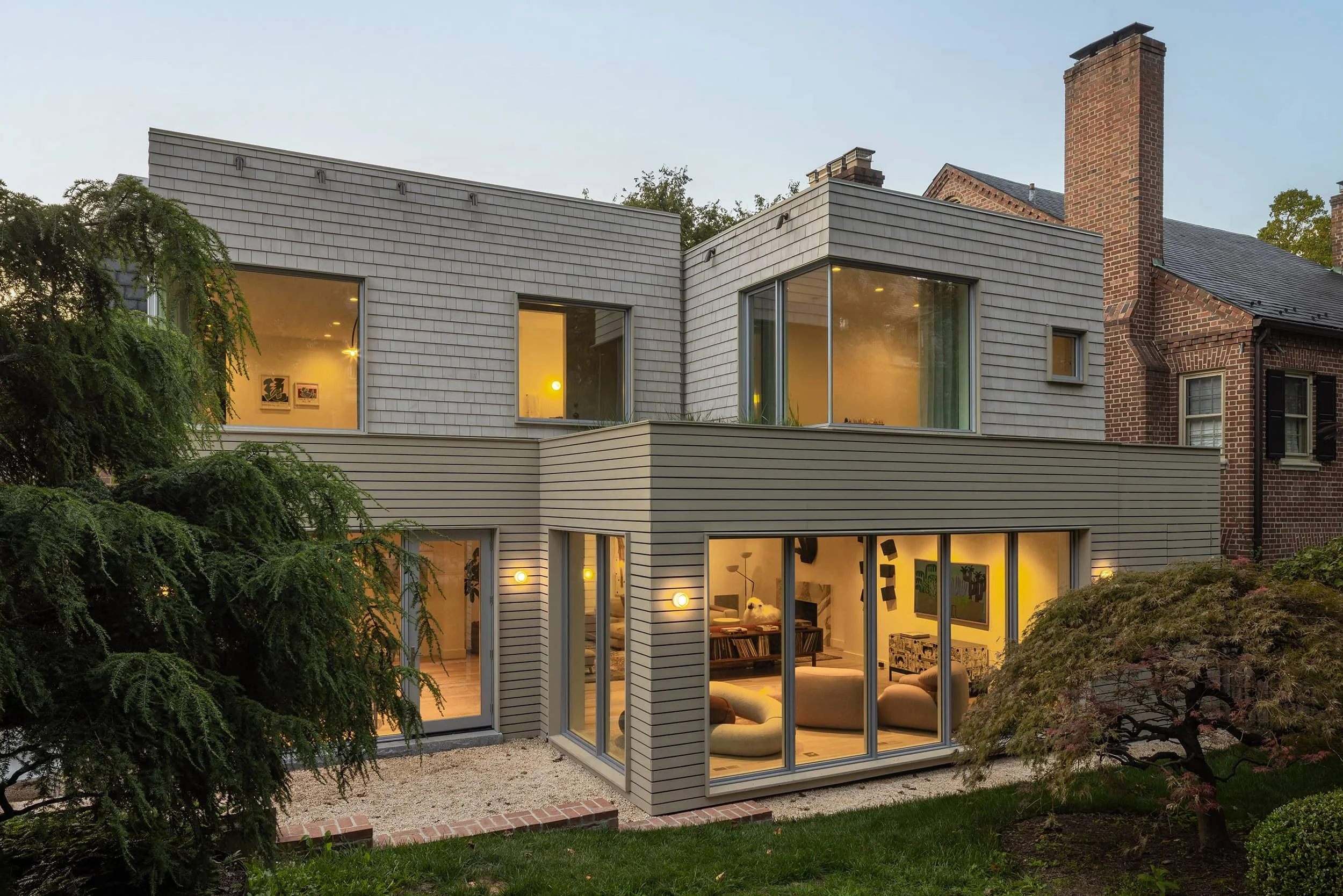 Contemporary home exterior with siding, glass and historic brick, designed by Fowlkes Studio in Kalorama Washington DC