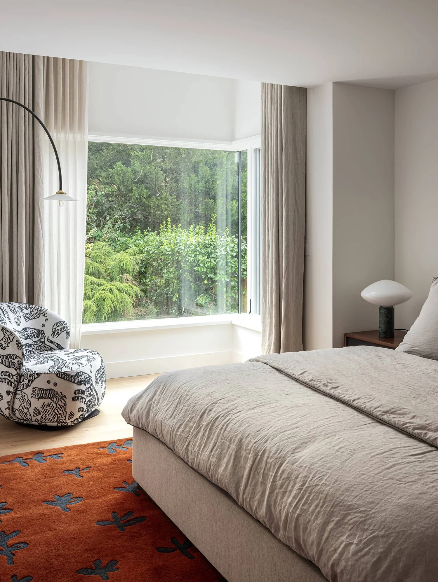 Modern corner window in bedroom overlooking garden in Washington, DC
