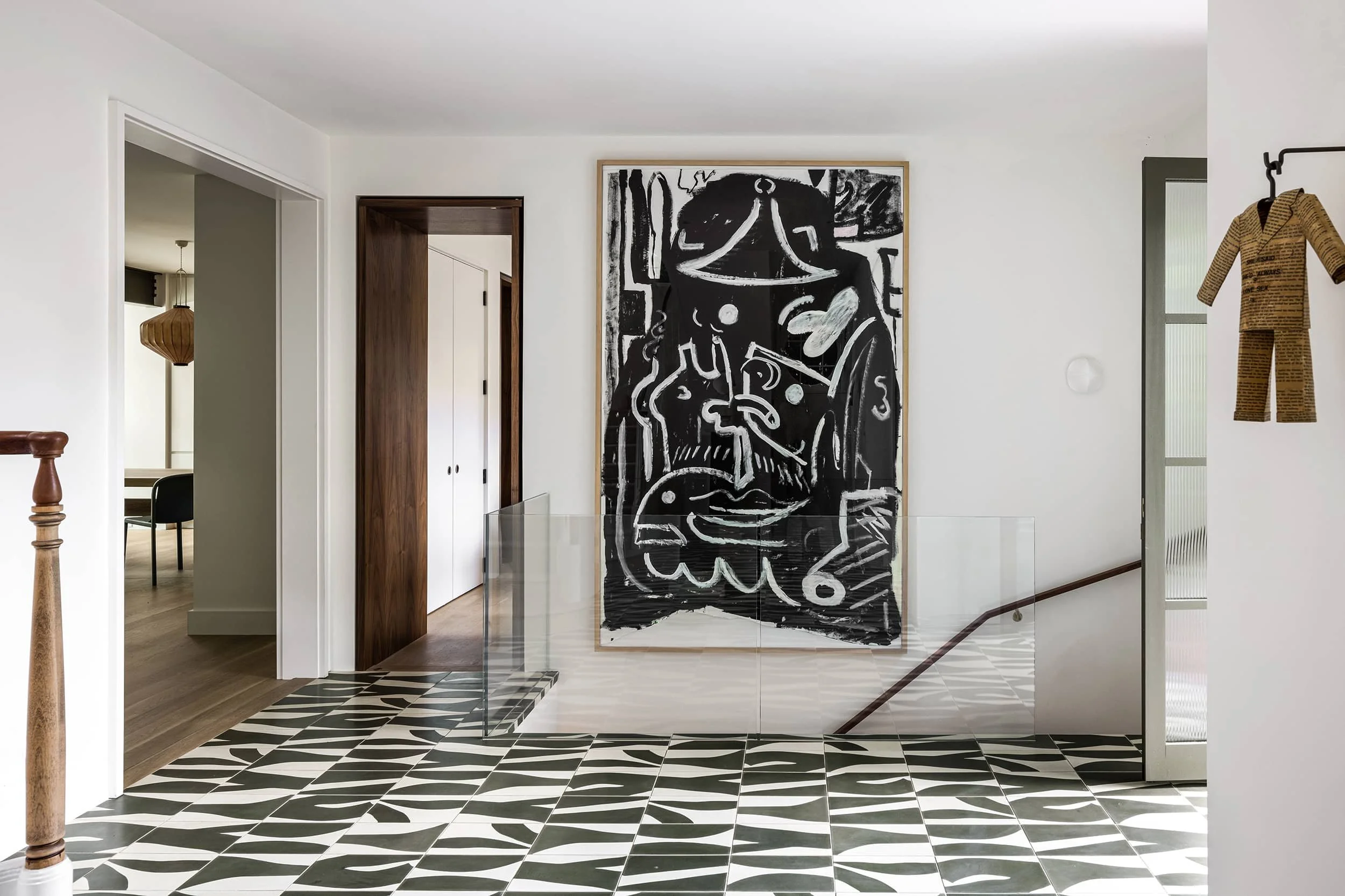 Modern monochromatic entryway with bold cement tile floor, abstract art designed by Fowlkes Studio in Washington DC