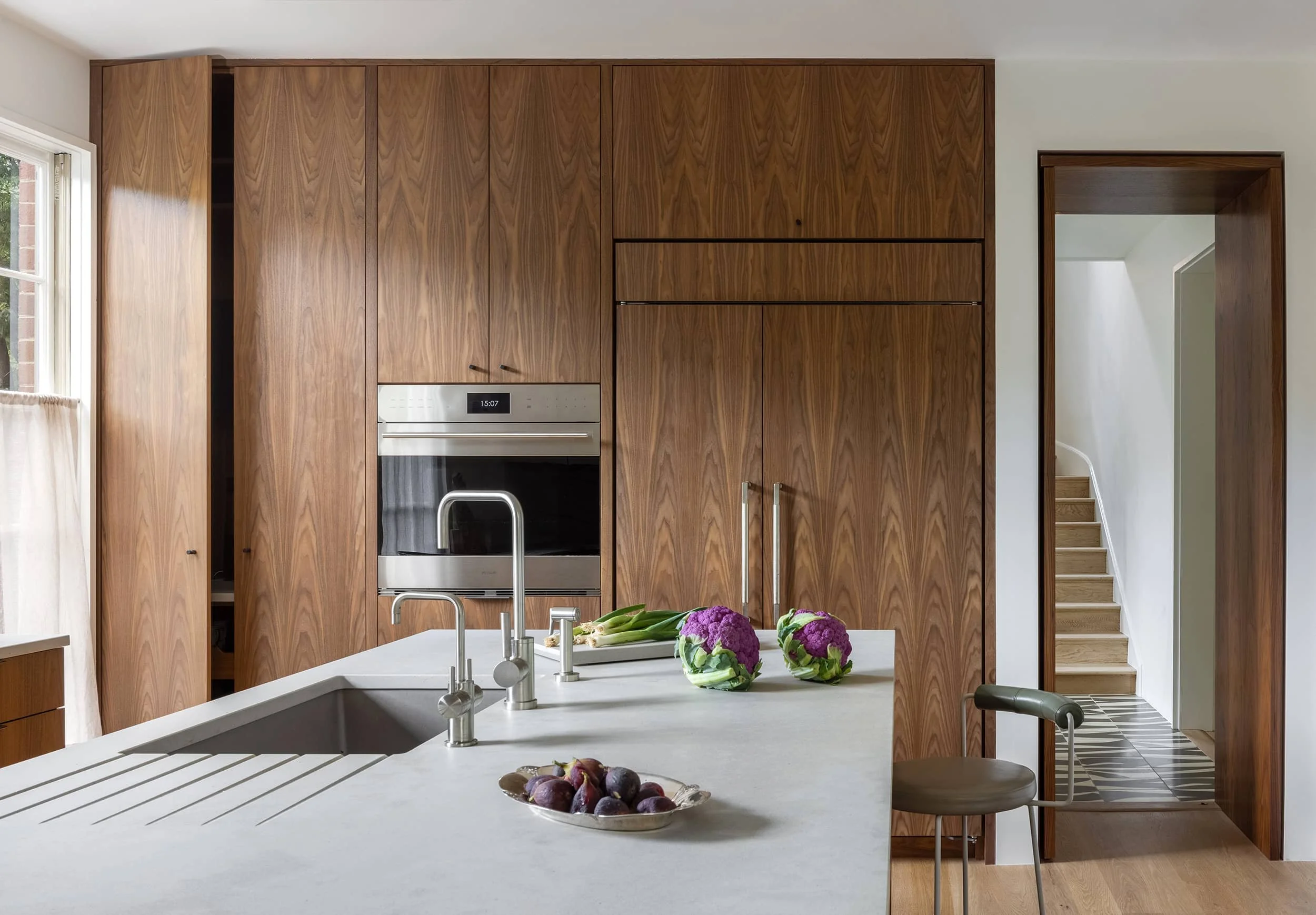 Sleek modern walnut kitchen designed by Fowlkes Studio in Washington DC