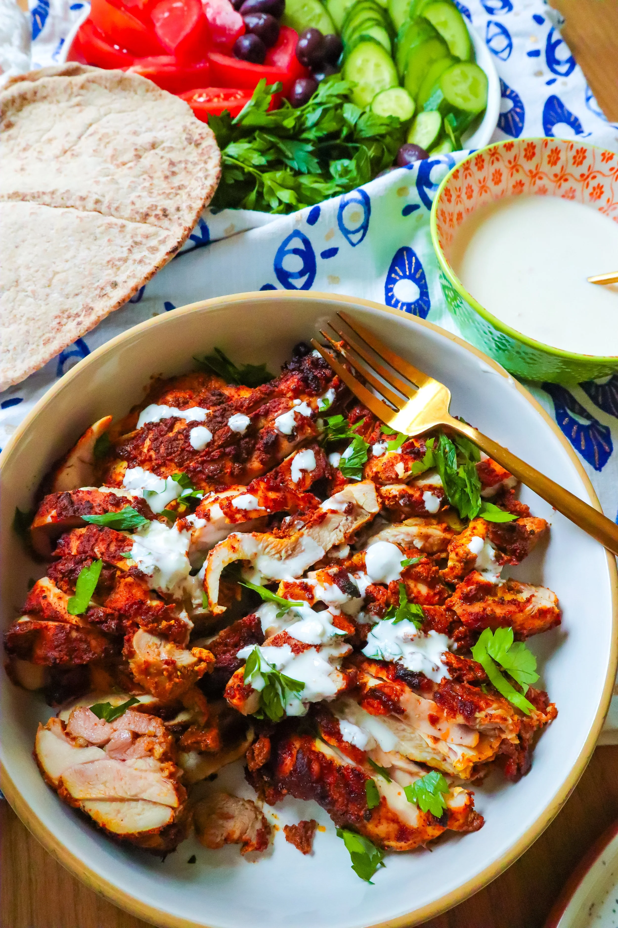 Air fryer chicken shawarma pita with creamy garlic sauce, cucumber, and tomato