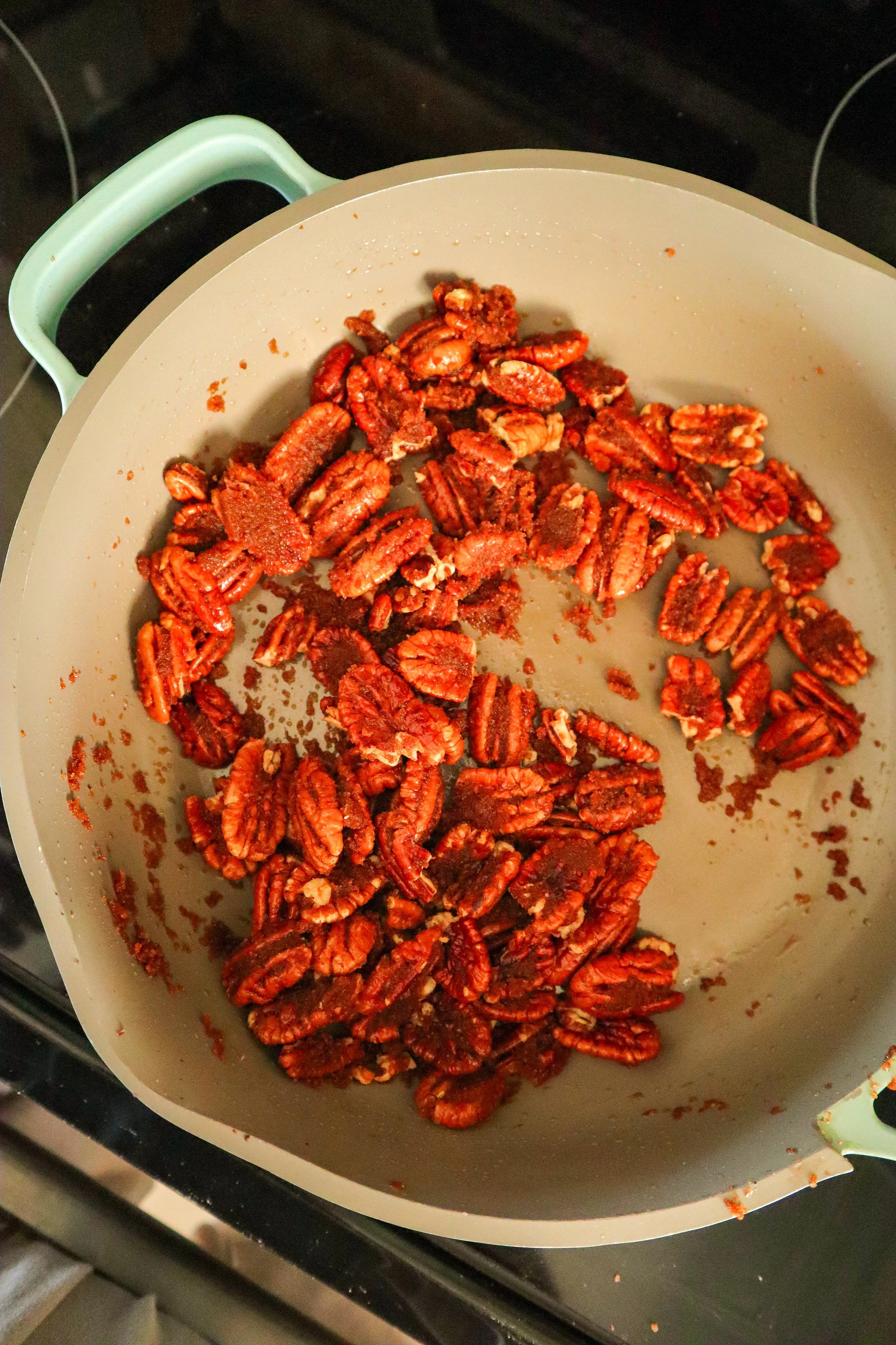  Coating pecans evenly in the bubbling caramel-like cinnamon sugar mixture. 