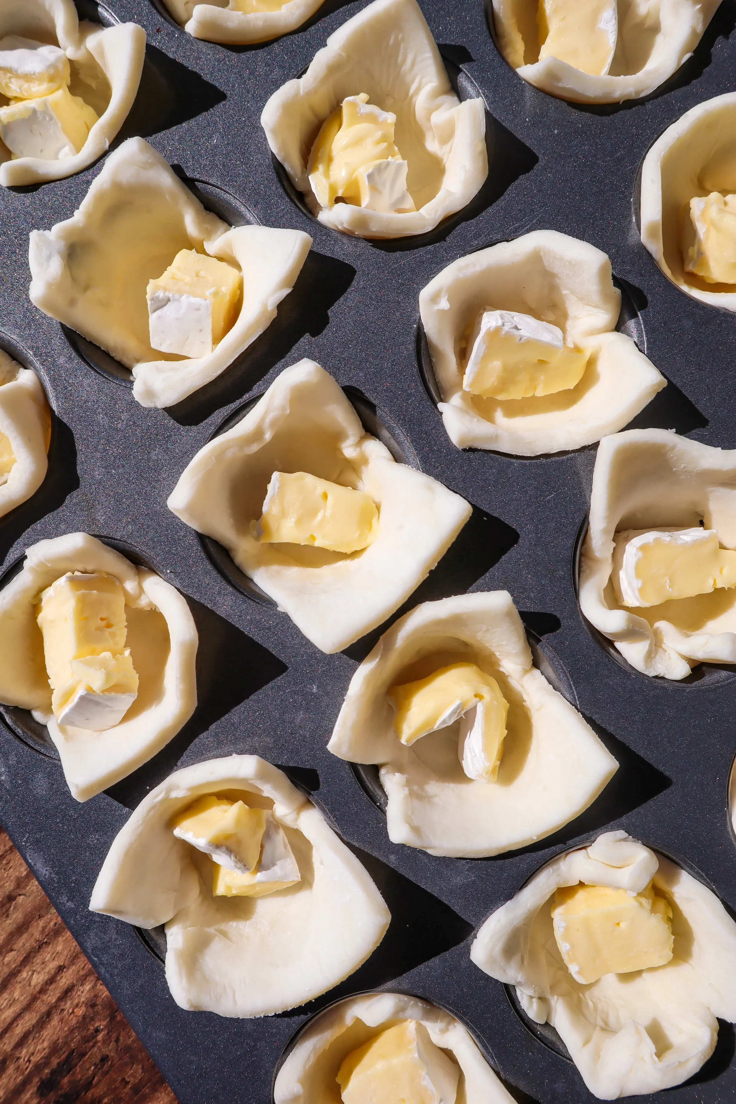 brie-cubes-in-puff-pastry-cups-before-baking.webp