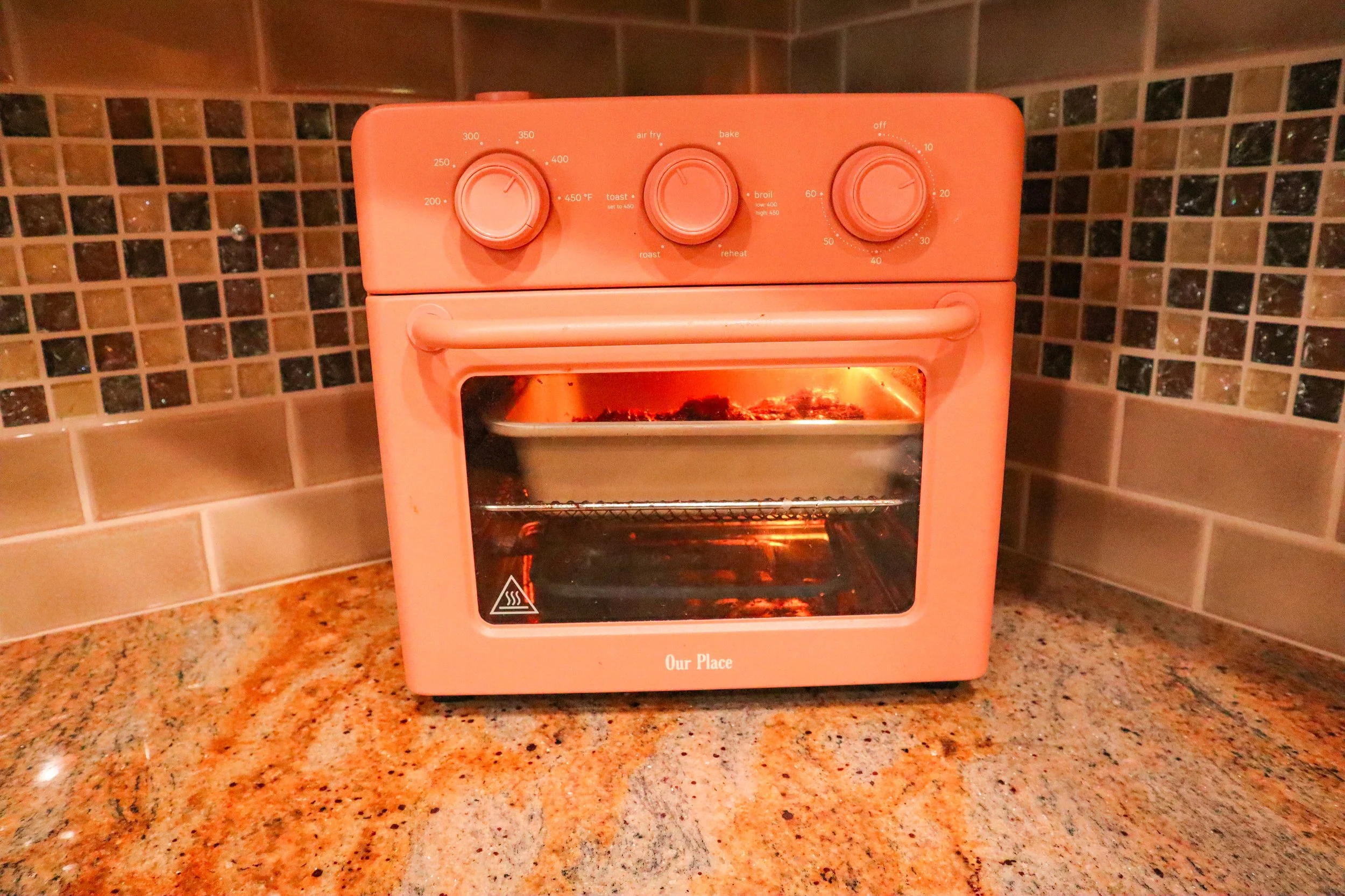 chicken air frying in Our Place Wonder Oven